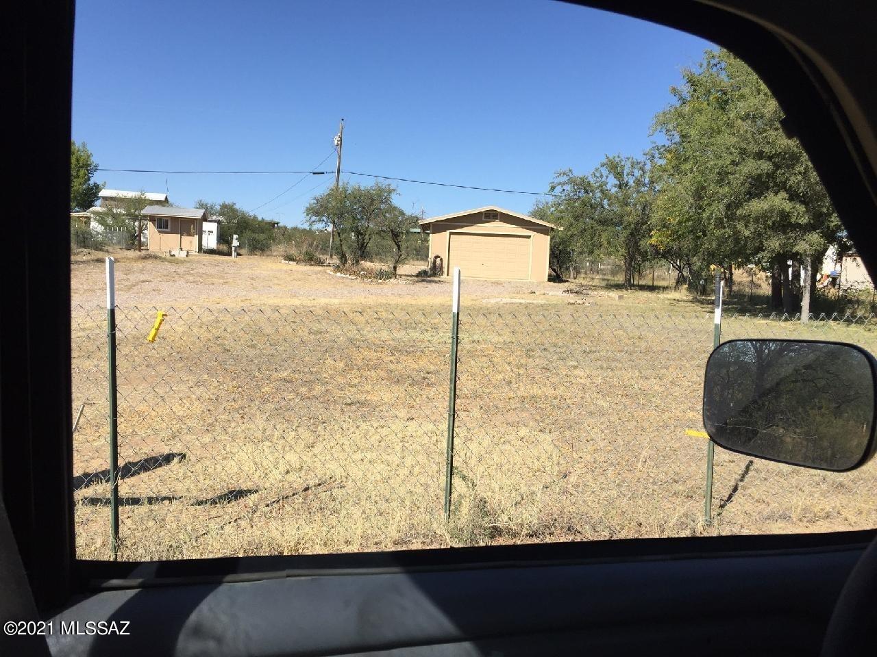 Awesome weekend getaway retreat  walking distance to the heart of Arivaca. This grand lot that includes a 2 car garage with attached covered patio. Storage room with laundry, and 2 Rv spots hook ups! Completely fenced as well. Come take a look! Come enjoy this laid back artistic community only 1 hour from Tucson!