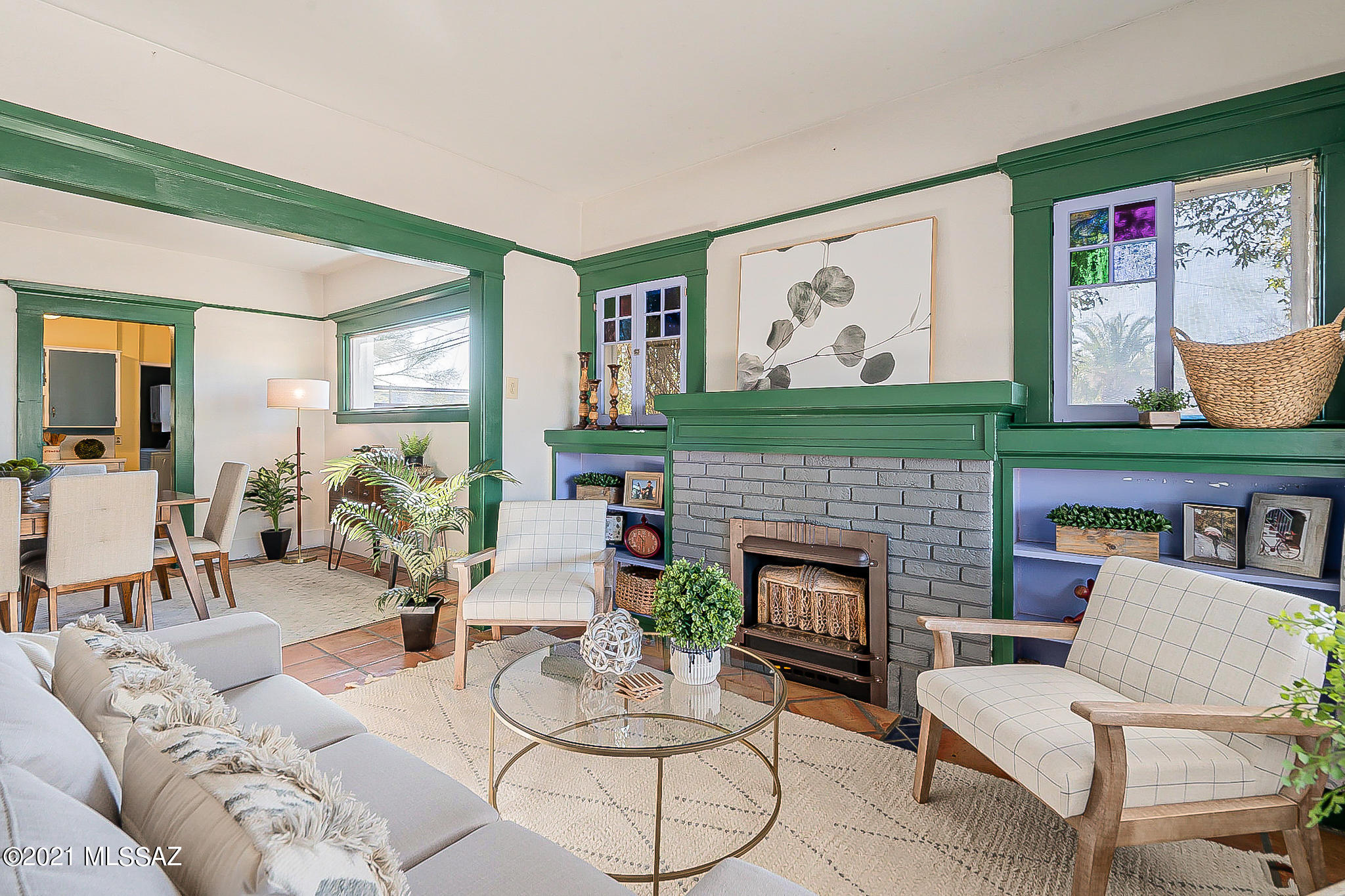 This Craftsman style bungalow in highly sought after Armory Park Historic District showcases rich character and timeless charm with its welcoming front porch, gorgeous wood and glass detailing, and cozy gas fireplace. Two spacious bedrooms plus a large den that could easily be converted back to a third bedroom. Possibilities are endless with the home's double-size, corner lot including a drive-through gate leading to the fully enclosed backyard. The backyard shop is perfect for an artist or hobbyist. Modern conveniences include PEX water pipes, newer water heater, newer evaporative cooler, and laundry room. Within walking distance of restaurants, breweries, shops, museums, and galleries!