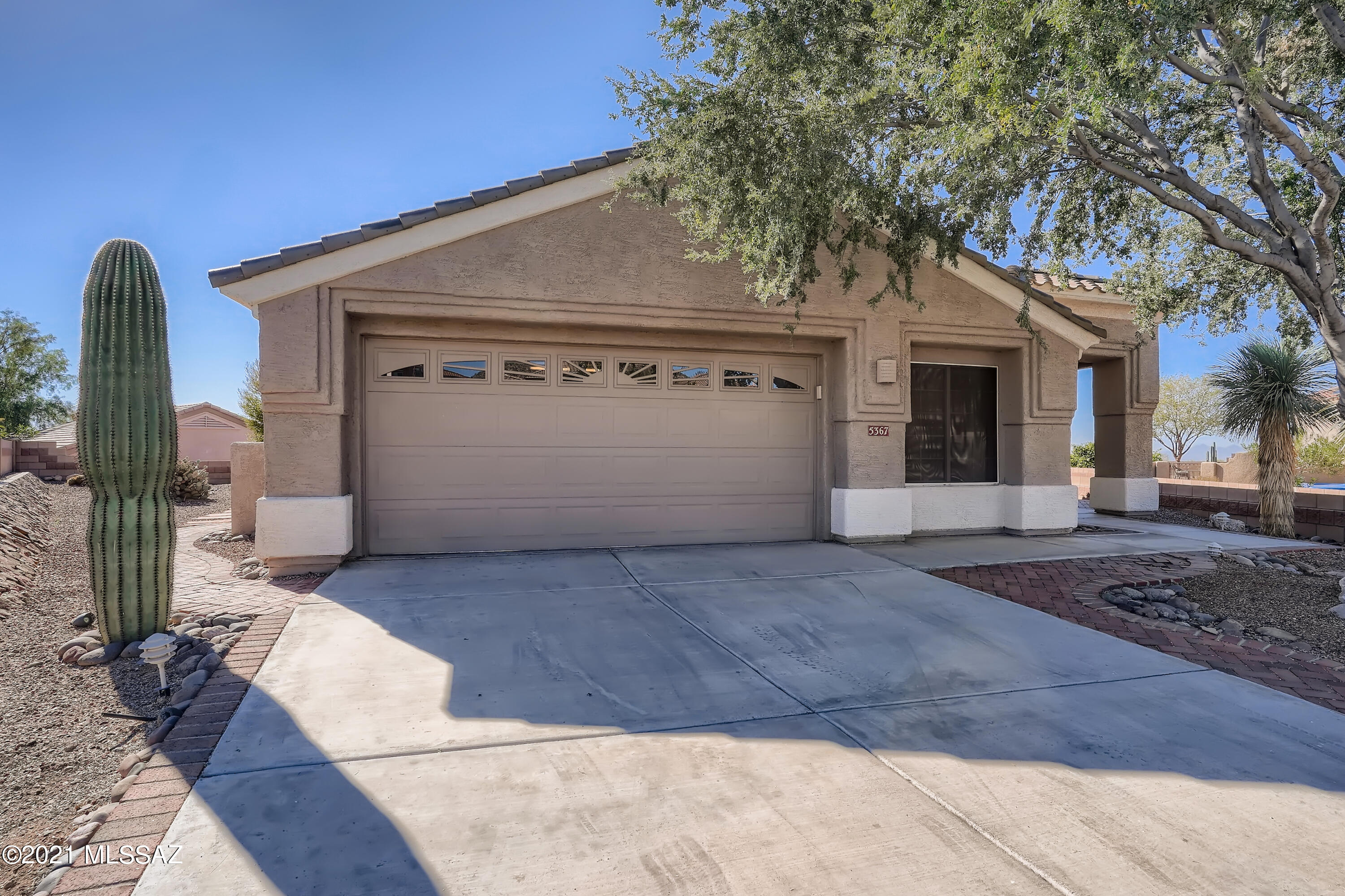 Welcome to this marvelous 2 bedroom, 2 bathroom home in the Highlands at Dove Mountain Community! A charming front yard with an inviting entrance leads you into a bright, spacious living room with a fireplace built-in entertainment, and dining area. You will love the open layout concept that lets natural light flow effortlessly from room to room. The kitchen is an entertainers' haven with sleek appliances, gorgeous countertops, a breakfast bar, and plenty of space to enjoy large gatherings. The light-filled primary bedroom features a walk-in closet space and an en suite bathroom with dual vanity. Enjoy hosting fall barbecues on the expansive back patio overlooking mountains in the fenced-in backyard. Great location with easy access to parks, shopping, dining, and more!