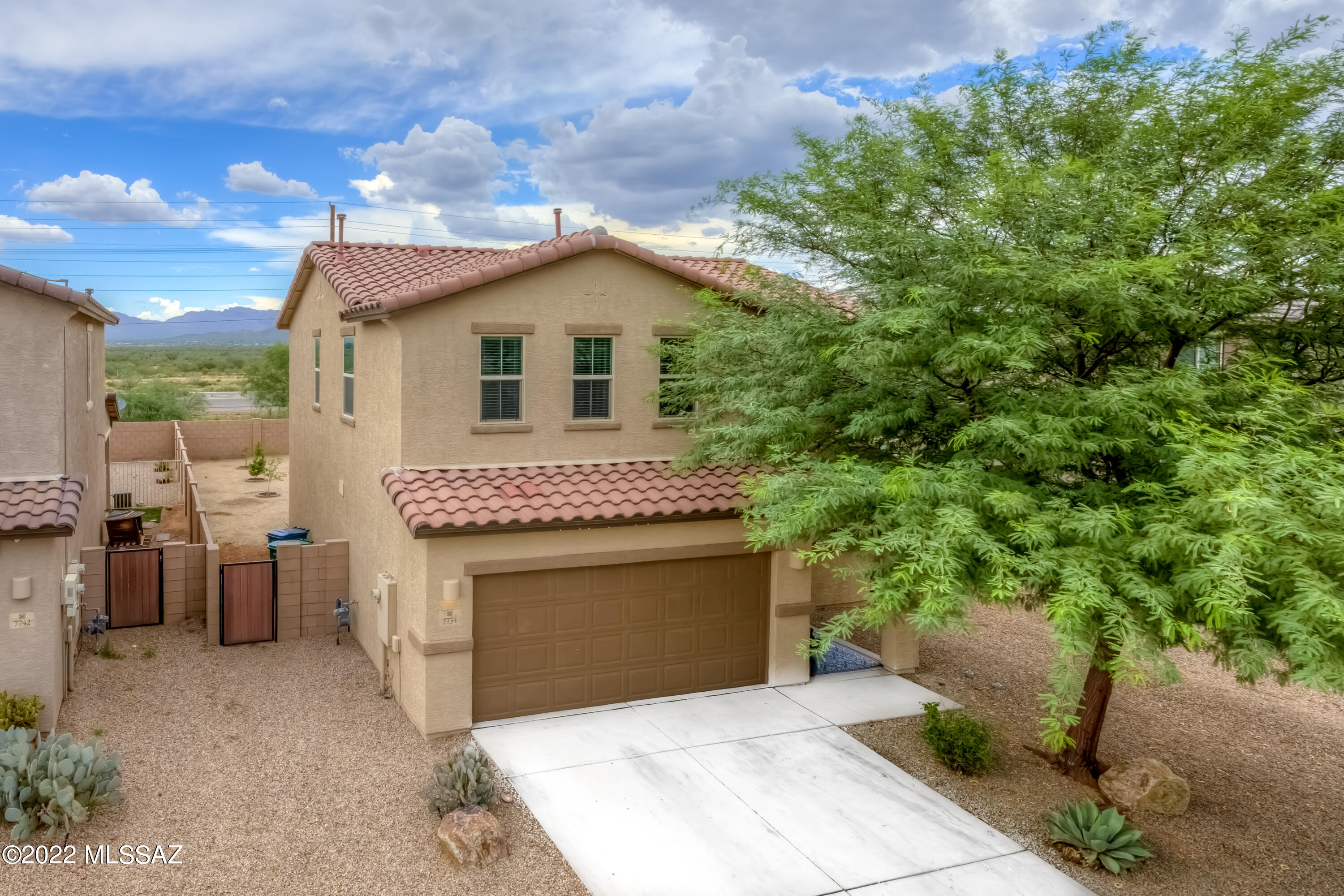Neutral & move in ready, light & bright w/ lots of upgrades in Vahalla Estates! This one is perfect for inside & outside entertaining. Open floor plan w/ large kitchen island. Stainless Steel appliances (gas cooking), granite countertops, large pantry & many cabinets make cooking a joy. Large slider out to the substantial back yard w/ mountain views, no rear neighbors, thriving citrus trees & a covered patio for relaxing. The spacious bedrooms are on the second floor, all w/ ceiling fans. Beautiful sliding barn doors grace the primary bedroom. Plenty of storage in both the house & garage. Dual zoned AC (up & down) for your comfort. The ADT security system stays & is transferrable. Great location, near shopping, dining, Saguaro National Park, hiking & Casino del Sol. Come & see today!