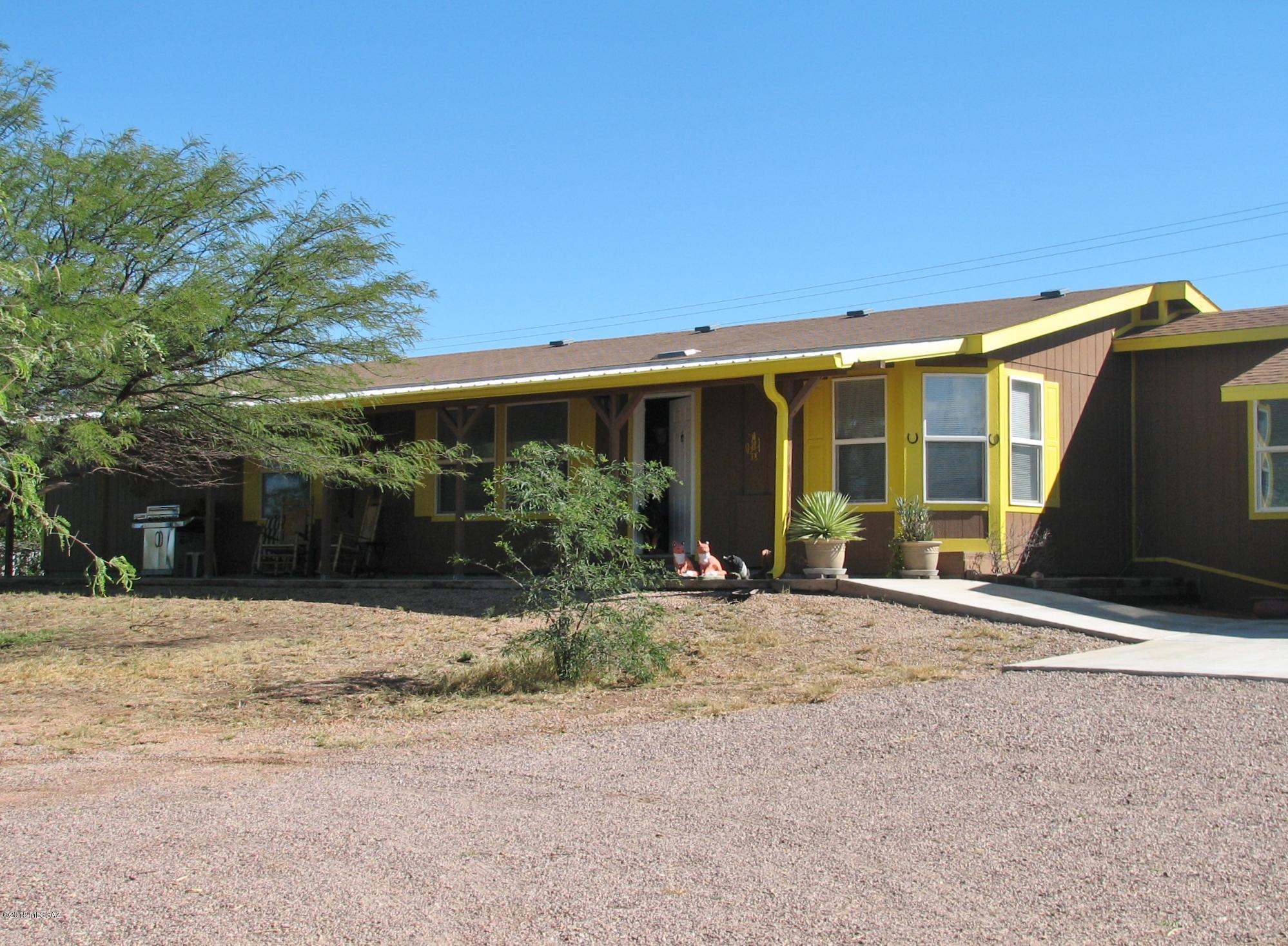 Pride of Ownership 2 BR + Den, being sold Fully Furnished with top of the line furnishings.  Move right in, even includes the dishes!  Spacious living room, formal dining, eat-in kitchen.  Laundry room with utility sink.  Whole house filtration system.  New in 2017 is a Workshop complete with AC, Hot water, Utility Sink and work bench !  New 2017 Double garage fully finished inside.  Some tools included in the sale!  Concrete pad with 30 amp electric beside the garage for an RV. Freshly painted inside and out.  Full length covered porch.   Fully fenced .94 acre lot with mature trees and plantings.   This is a rare opportunity for winter visitors to buy a fully furnished home