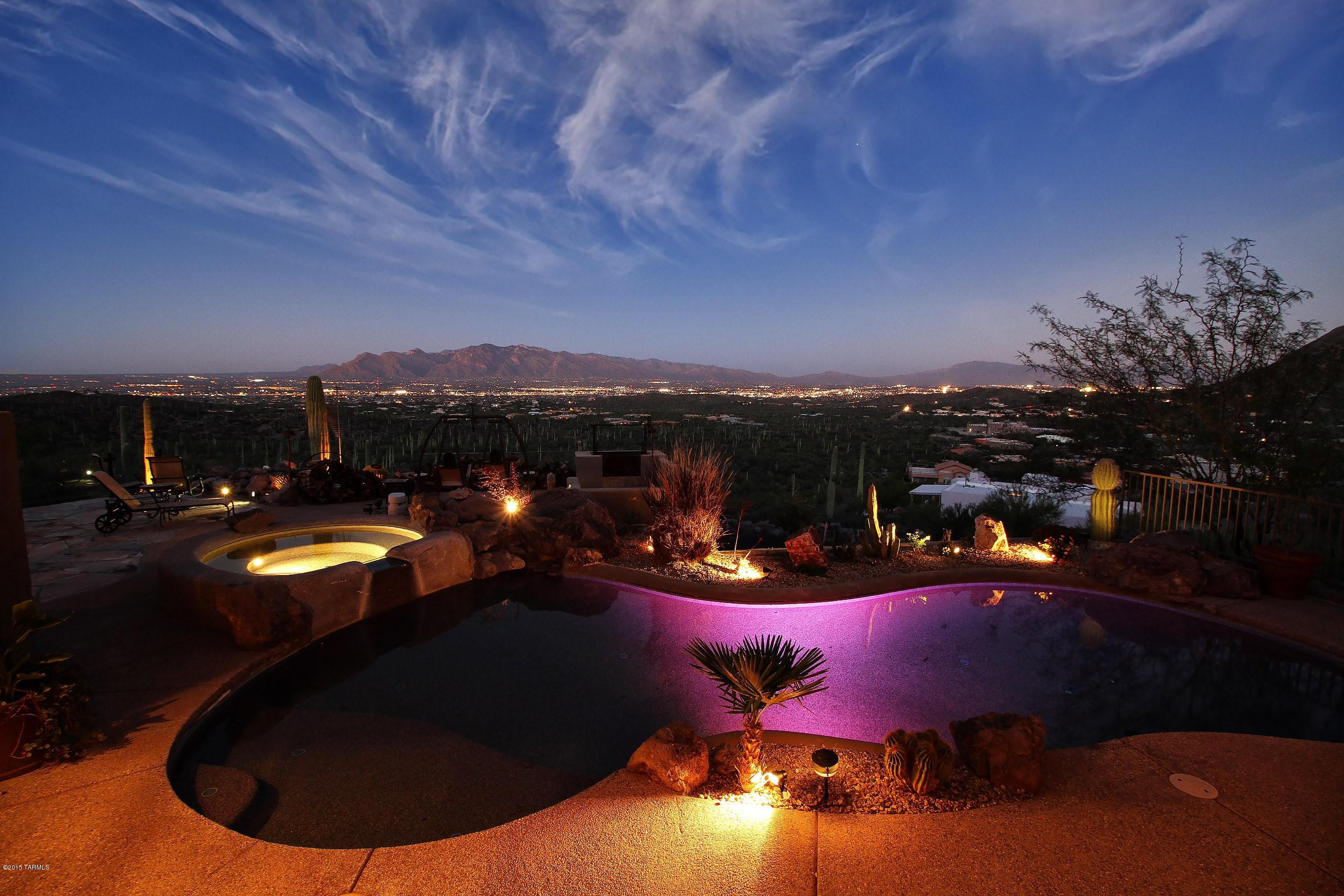 Brace yourself for these awe-inspiring views as they are not for the faint of heart from this King of the Hill southwest contemporary home with soaring wood beamed ceilings, huge picture windows,  fantastic outdoor living spaces, awesome pool & spa, fireplace, koi pond & multiple covered patios with views in every direction from inside & out. Other features include a gorgeous kitchen with granite, SS appliances w/Wolf range & beautiful cabinetry. Master with huge city light views, access to outdoor living and spacious bath w/dual vanities & wonderful Mexican tile details. Den/office with  view of rugged desert oasis.  Formal dining room for amazing dinner parties looking down on the city life.  Private resort like lifestyle all backing up to Tucson Mountain Park.