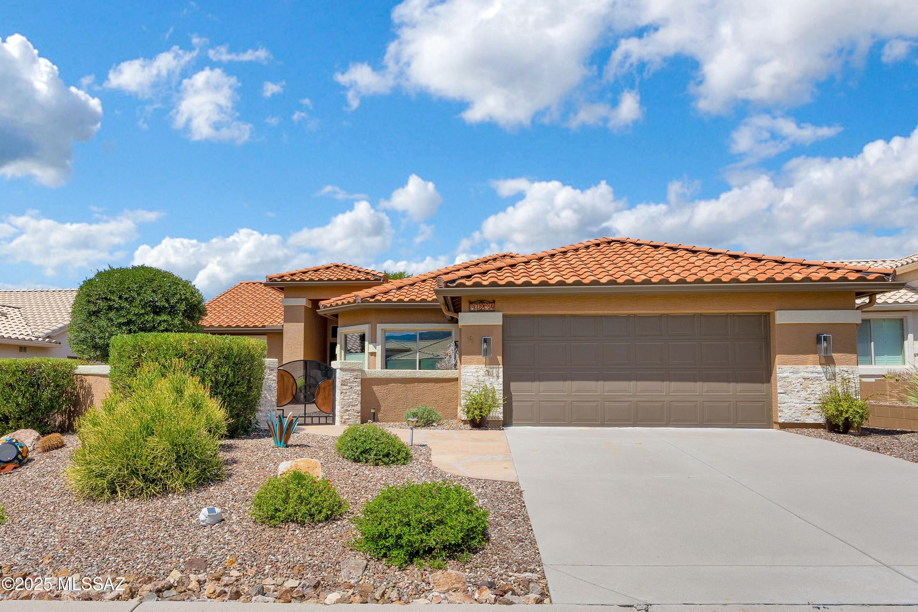 Updated Laredo with Paver Courtyard with Mountain Views! ''4/2026 Roof Underlayment Replaced'', 2024 Exterior Home Painted, 2022 Irrigation System Replaced, & 2022 Added Gutters. Great Curb Appeal! 2 Custom Entry Gates & Stacked Stone Front. Great Room has Electric Fireplace & Slider to Patio. Kitchen has Quartz Counters, Stainless Appliances, Lots of Cabinets, Island & Dining Area. Owner's Suite has Bathroom with Walk-in Shower & Walk-in Closet. 2 Guest Bedrooms have Closets & Guest Bathroom with Walk-in Shower nearby. 3rd Bedroom could serve as Den/Office/. Laundry Room with W/D, Cabinets & Desk Area. Tile Floors in most areas of home. 2 Car Garage has 2022 HVAC, 2023 Recirc. Pump, 2024 Garage Door & Storage Cabinets. Covered Paver Patio with extended Pavers, Fountain, & Raised Patio!