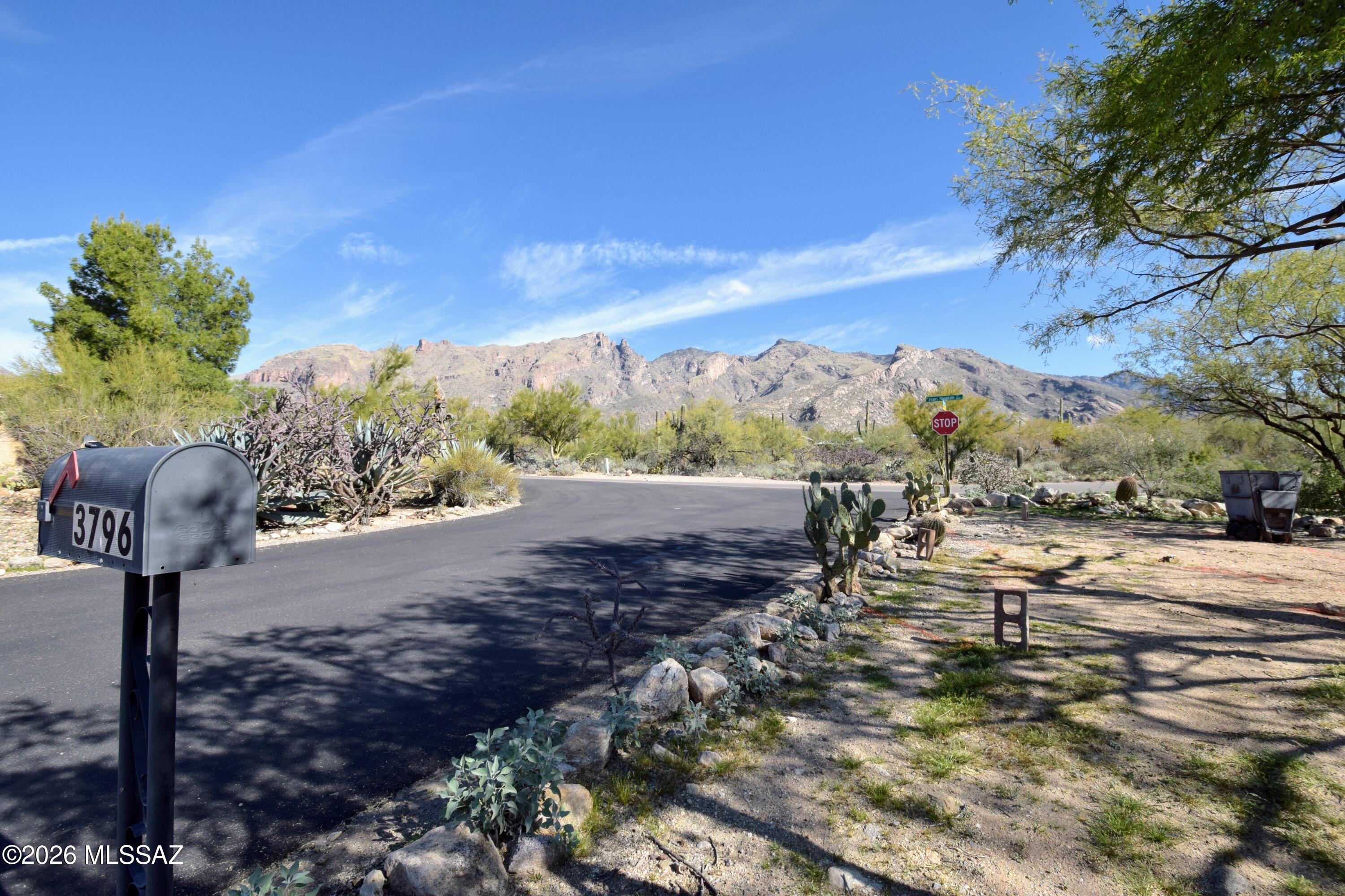 Experience elevated living in this stunning 1,674 3 Bedroom 2 Bath single-family home located in the sought after Foothills Clusters neighborhood of the Catalina Foothills. This recently remodeled residence sits on a spacious .4-acre corner lot, offering breathtaking mountain views to the north and sparkling city lights to the south. The interior showcases a sophisticated modern aesthetic with large-format tile floors, new windows, solid wood interior doors, and contemporary light fixtures throughout. At the heart of the home, the designer kitchen features custom wood cabinetry, sleek quartz countertops, stainless steel appliances, and an expansive island with a breakfast bar and integrated storage. The inviting living space is anchored by a traditional beehive fireplace, perfect for cozy desert evenings. This home offers updated bathrooms, including a luxurious primary suite boasting dual closets and an en suite with an extra-wide double vanity and a custom glass walk-in shower. Practical amenities include central air conditioning and heating, a full-size washer and dryer, and an attached two-car garage. For added seclusion, privacy fencing will be installed in the backyard prior to occupancy. This exceptional property combines high-end finishes with the natural beauty of Tucson's most sought-after area. This home is being offered ONLY to NON-SMOKING tenants. Pets are subject to owner approval.