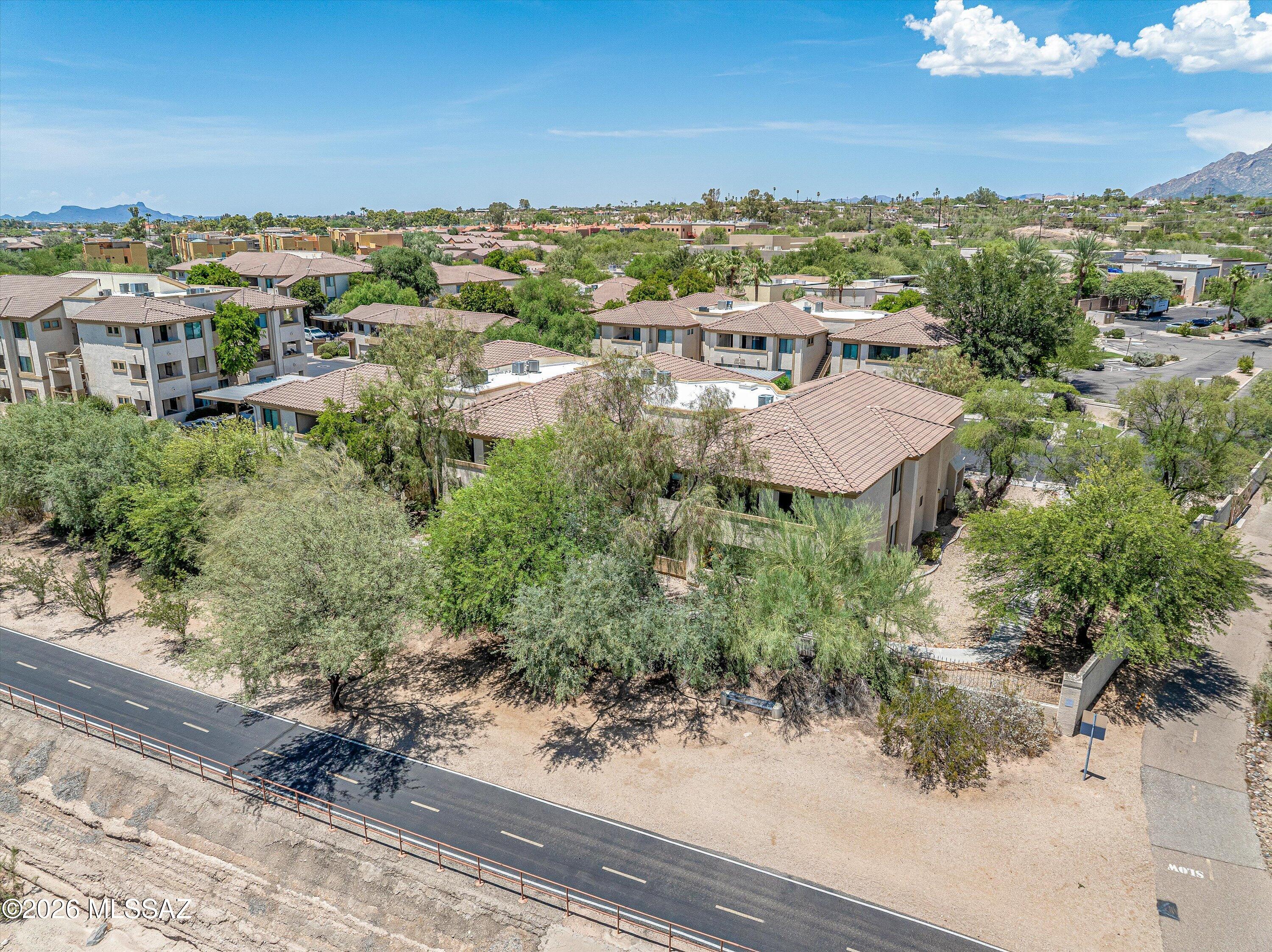Experience elevated desert living in this spacious ground floor corner unit condo overlooking the Rillito Riverwalk / The Loop in the gated community of Rio Del Sol.  This private Northern Tucson property features an open split bedroom layout with an abundance of natural light, eat-in kitchen with stainless steel appliances, cozy electric fireplace, spacious covered patio with storage closet, luxury vinyl / tile flooring, washer / dryer included, primary suite with recently installed walk-in shower and roomy closet and resort style HOA amenities.  The community of Rio Del Sol / Villas At Hacienda Del Sol include two pools & spas, clubhouse with gym, ramadas with BBQ grills and direct access to the Loop, providing easy access to hiking, biking and nearby restaurants / shopping.