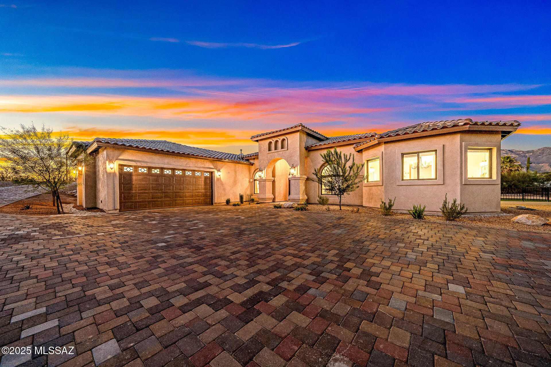 Discover refined desert living in this brand-new luxury residence perfectly situated within Pontatoc Ranch in the Catalina Foothills. Designed for today's discerning buyer, this contemporary masterpiece combines timeless elegance with modern sophistication, offering the perfect balance of privacy, style, and convenience. Set on a 1.03-acre private lot, the home makes an impressive first impression with its expansive paver driveway, mission-tile roof, and a custom iron entry door that sets the tone for the exceptional craftsmanship inside. Step into a spacious, open-concept floor plan with no interior steps, soaring ceilings, and walls of glass. Rich engineered wood flooring and exposed beams add warmth and character throughout. The 3,696 sq. ft. layout offers 5 bedrooms and 5 baths, 4 rooms feature an en-suite for ultimate comfort and privacy. A split-bedroom design includes one suite with direct exterior access, ideal for guests or multi-generational living. The heart of the home is the designer kitchen, providing dolomite countertops, custom cabinetry, a large center island, a breakfast bar, and stainless steel appliances including a professional-grade gas range. The family room, open to the kitchen, features a fireplace, a beamed ceiling, and a breakfast area. The spacious living room, also open to the kitchen, offers a formal dining area, perfect for seamless entertaining. The luxurious primary suite is a retreat, featuring direct patio access, dual vanities, dual walk-in closets, a free-standing soaking tub, and a glass-enclosed shower. The outdoor living space boasts a large, covered patio, lush turf yard, and ample additional space to design your dream backyard oasis, complete with room for a pool, spa, or outdoor kitchen. Located just minutes from high-end shopping, dining, golf, and top-rated schools, this home captures the essence of luxury living in the Foothills. A rare opportunity to own new construction in one of Tucson's most sought-after enclaves. A custom pool designer has created preliminary renderings and conceptual plans for a fully customizable pool build. Some design images are included in the photos for inspiration and orientation. Additional customization, features and enhancements can be incorporated into the final design and included in the purchase price for financing, if desired. See it today before it's gone.