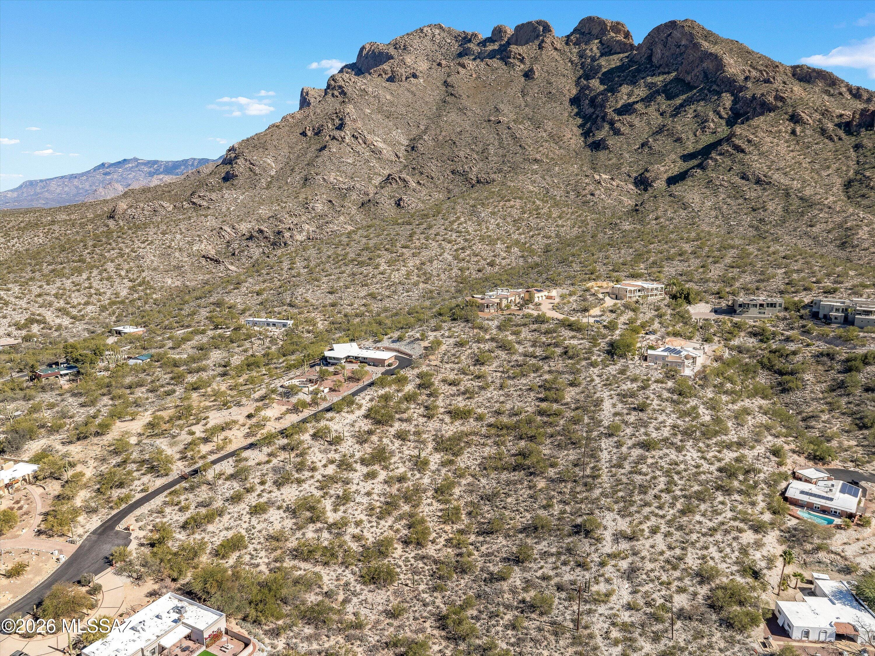 Experience unparalleled serenity at the foothills of the Catalina Mountains. This rare 1.93 acre gem offers expansive, panoramic views stretching as far as the eye can see, from rugged peaks to the twinkling city lights below. Perched high on the hill, this lot provides the quiet and peace that is becoming increasingly scarce in the Old Pueblo, yet remains minutes to all conveniences. It's more than just land; it's a sanctuary for your peace of mind. With all utilities easily accessible, this blank canvas is ready for your creative vision. Don't miss the opportunity to build your dream home where desert beauty meets city convenience. The views you've been dreaming of are right here. Don't let this one slip through your fingers.