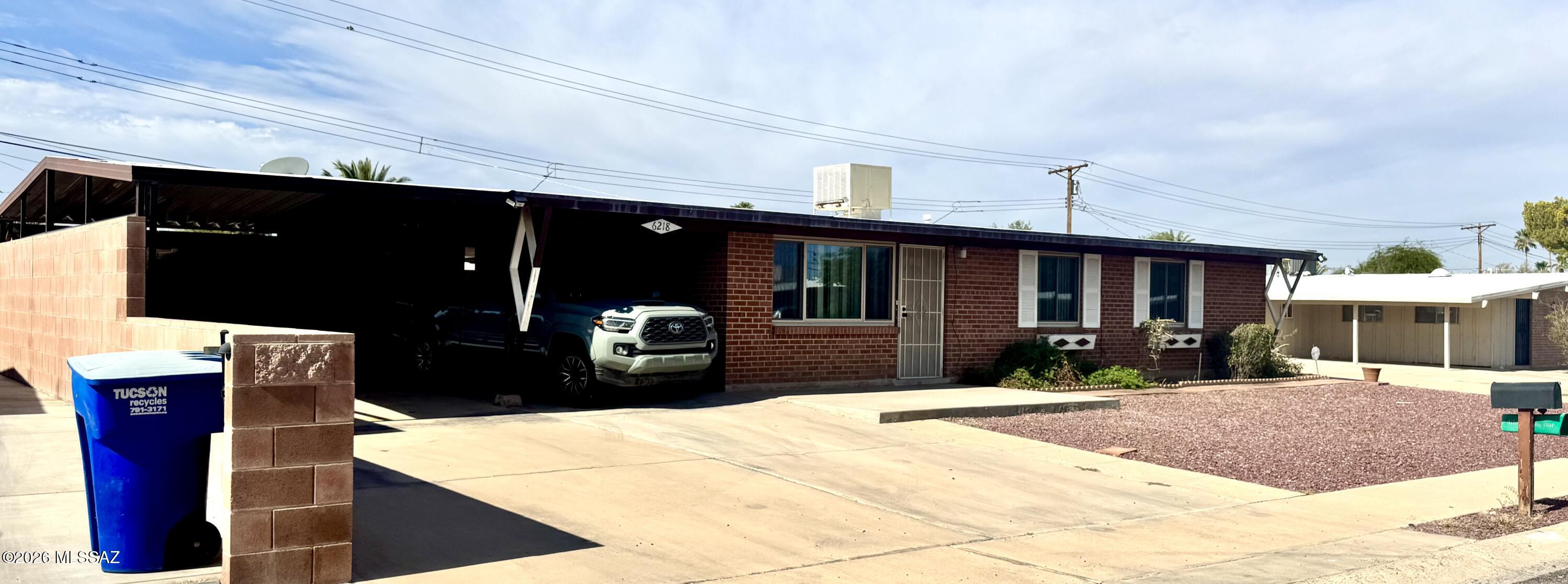 Mid-Century Modern red brick home in central Tucson. It's got a 2.5 car carport with large covered rear patio.