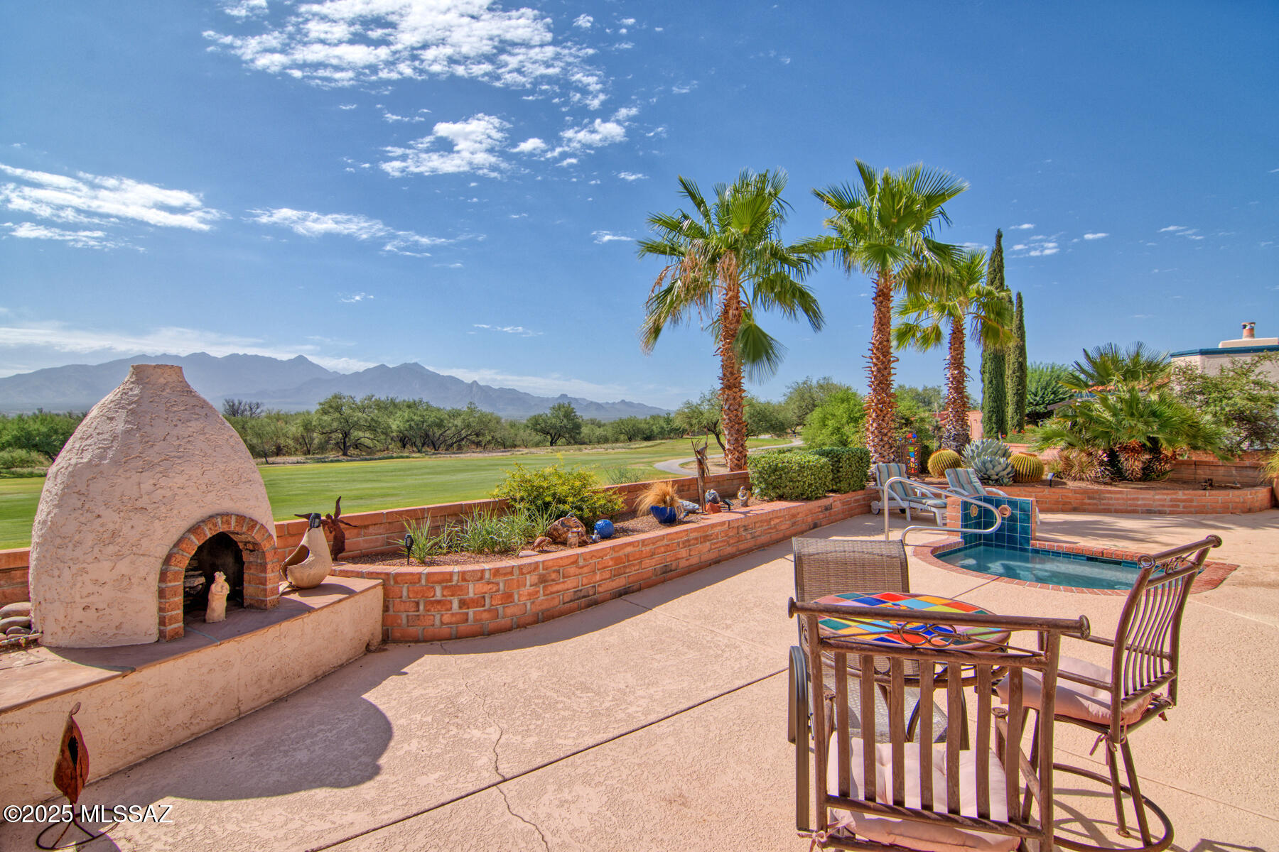 Beautifully maintained single-level Green Valley home in San Ignacio Golf Estates with owned solar, a brand new roof with warranty, no interior steps, and sweeping mountain, lake, and golf course views. This spacious 3 bedroom, 2 bathroom home offers a desirable split-bedroom floor plan, exceptional privacy with just one adjacent neighbor, and the ideal blend of comfort, efficiency, and Arizona lifestyle living.

Inside, soaring 12-foot ceilings, expansive windows, a gas fireplace, and built-in surround sound create an inviting open living space designed for both relaxing and entertaining. The kitchen features granite countertops, gas cooktop, double ovens, center island, abundant cabinetry, and a smart Samsung French-door refrigerator. The spacious primary suite includes a sitting area, large walk-in closet, dual vanities, soaking tub, and walk-in shower.Step outside to enjoy true resort-style living with a gas-heated spa resurfaced in 2025, gas beehive fireplace, gated front paver patio, and low-maintenance desert landscaping--all perfectly positioned to take in the stunning views. Additional upgrades include zoned HVAC with one unit replaced in 2023, solar screens, electric roll-down shades installed in 2024, oversized garage with built-in storage, transferable termite warranty, and owned solar for long-term energy savings. Required GVR membership provides access to pools, spas, fitness centers, pickleball, tennis, clubs, and social activities, making this an exceptional opportunity to enjoy the active Green Valley lifestyle.