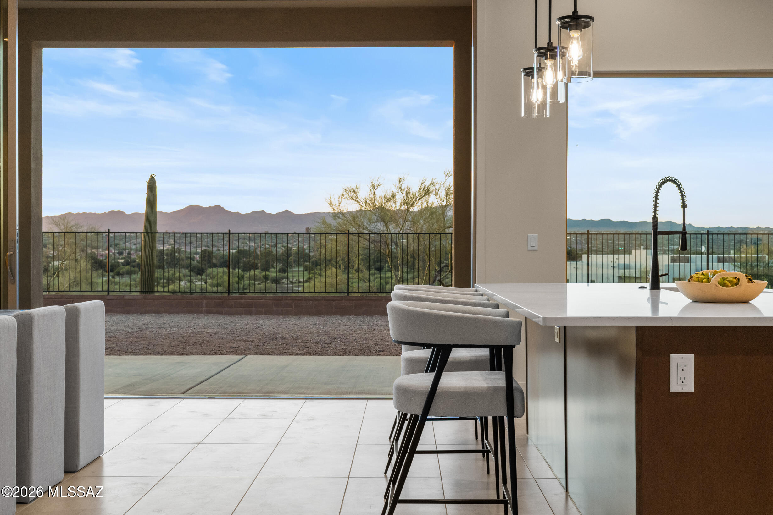 Experience luxury living overlooking the Omni Tucson National Golf Course in this beautifully designed new construction Mesquite plan! Located in a gated community, this home offers 3 en-suite bedrooms with walk-in closets, a spacious office, and an oversized 51-foot patio perfect for enjoying Tucson's indoor-outdoor lifestyle! The open-concept great room features 12-foot ceilings and a 16'x10' multi-panel sliding glass door that frames stunning desert views! A gourmet kitchen with a large island, walk-in pantry, and butler's pantry is ideal for entertaining. Additional highlights include a designer curated interior, 5' pivot from door, and a 3 car garage with extra storage.