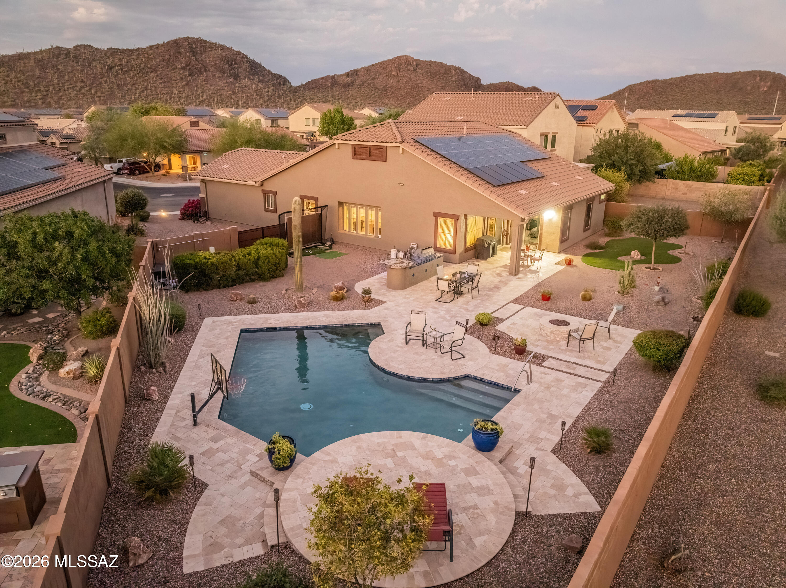 Better than new and ready for its next owner! This beautifully maintained Kramden model in the desirable Saguaro Bloom community offers 3 bedrooms, a den, 3-car garage, and sits on one of the largest lots in the subdivision.  OWNED SOLAR! 

The open floor plan is enhanced by soaring 11-foot ceilings, abundant natural light, and quality finishes throughout. The kitchen is the heart of the home, featuring granite countertops, upgraded cabinetry, stainless steel appliances, and plenty of space for gathering with family and friends.

Step outside and discover what truly sets this home apart. The expansive backyard has been transformed into a private desert retreat with custom landscaping, offering plenty of room to relax, entertain, or create your dream outdoor oasis. Whether you're enjoying the beautiful mountain views, hosting a backyard barbecue, or simply taking in the Arizona sunsets, this oversized lot provides space and privacy that's hard to find.

With a 3-car garage, move-in-ready condition, and all the advantages of a newer home without the wait, this property offers exceptional value. Conveniently located near neighborhood parks, shopping, dining, and easy freeway access, this is a home you'll want to see for yourself.