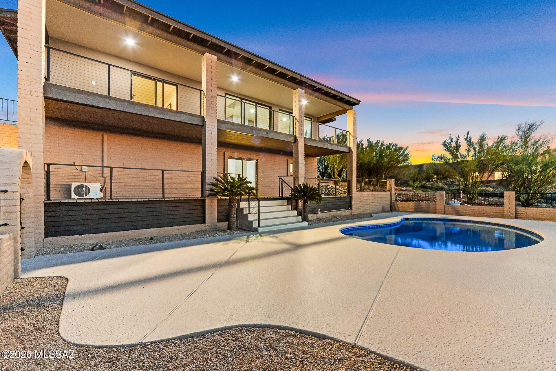 Welcome Home! This fully refreshed Foothills view residence delivers an immediate sense of wow--clean architectural lines, warm modern finishes, and expansive views that seamlessly blend elevated living with the beauty of the pristine Sonoran Desert!

The heart of the home is a light-filled great room anchored by a stylish fireplace, flowing effortlessly into a showpiece chef's kitchen featuring leathered quartzite countertops, custom cabinetry, and premium ZLINE appliances--designed for both everyday living and effortless entertaining! Floor-to-ceiling walls of sliding glass open the home to the outdoors, framing big-sky vistas, mountain backdrops by day, and glittering city lights by night.

Upstairs, the primary suite is a true retreat, offering private view-deck access and a spa-inspired bath with elevated finishes. Downstairs provides exceptional flexibility with an ideal guest suite and a dedicated entertainment/theater room, perfect for game days and movie nights (yes 100" screen ready). Outside, enjoy multiple view patios and decks, a sparkling pool, and a low-maintenance desert setting curated for easy living and unforgettable sunsets.

Every detail has been thoughtfully refreshed. Major upgrades include new HVAC systems, a new roof, new water heaters, and updated plumbing and electrical, offering peace of mind and true move-in readiness!

This is a rare opportunity for Foothills luxury living where views, design, and lifestyle come together.
Come experience it for yourself!