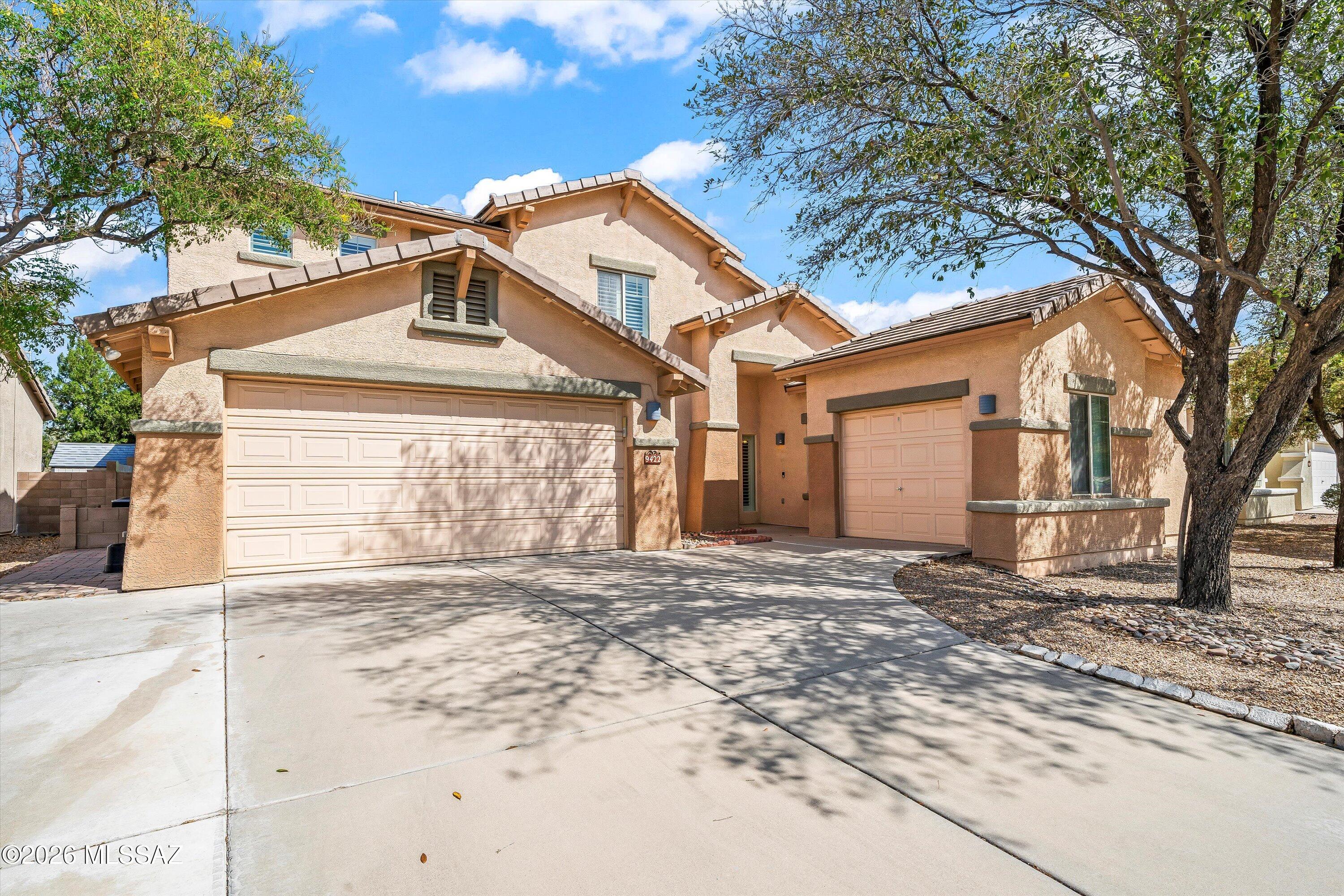 Experience the perfect blend of space and scenery in this stunning 3,121 sq. ft. Continental Ranch home, now offered at a newly adjusted price. Boasting 5 bedrooms, 3 bathrooms, and a rare 3-car split garage, this residence impresses from the moment you enter with dramatic 20-foot vaulted ceilings and an abundance of natural light throughout the open-concept living areas. The chef-inspired kitchen features a center island and walk-in pantry, while the primary suite offers a private retreat with dual vanities and a soaking tub. Step outside to a backyard oasis with no rear neighbors, offering unobstructed, breathtaking views of the Santa Catalina Mountains. Complete with an energy-efficient leased solar system and access to premier community amenities including pools, spas, & sports court, this home offers an incredible value in a prime Marana location near I-10 and shopping.