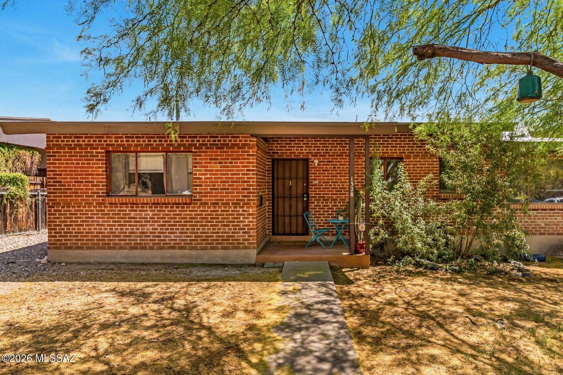 With its proximity to major employers, the University of Arizona, and Banner medical facilities, this tri-plex property presents a practical and flexible opportunity in one of Tucson's most consistently in-demand rental areas. 
The property includes a three-bedroom, one-bath main unit featuring private laundry, a covered patio, concrete floors, and a remodeled kitchen and bathroom. Two additional units--a one-bedroom (currently vacant) and a studio with an existing lease in place--provide immediate income potential or flexibility for future use.
The setup is well suited for a live-in owner looking to offset expenses with rental income, or for an investor seeking a manageable multi-unit property in a superb central location.
Recent improvements include HVAC systems updated in 2020 (Main 3/1) and 2021 (studio & 1/1), a roof replacement in 2025, upgraded electrical panels, and a new metal fence separating the yards in 2026. Electric service is separately metered for each unit. Parking is ample, with a two-car carport and three additional spaces.
Located within walking distance to the college of Medicine and law school, this brick tri-plex offers both owner-occupants or investors a unique prospect for income, or would make a perfect home for students with room for visiting parents. After three decades of ownership this property awaits a new steward.