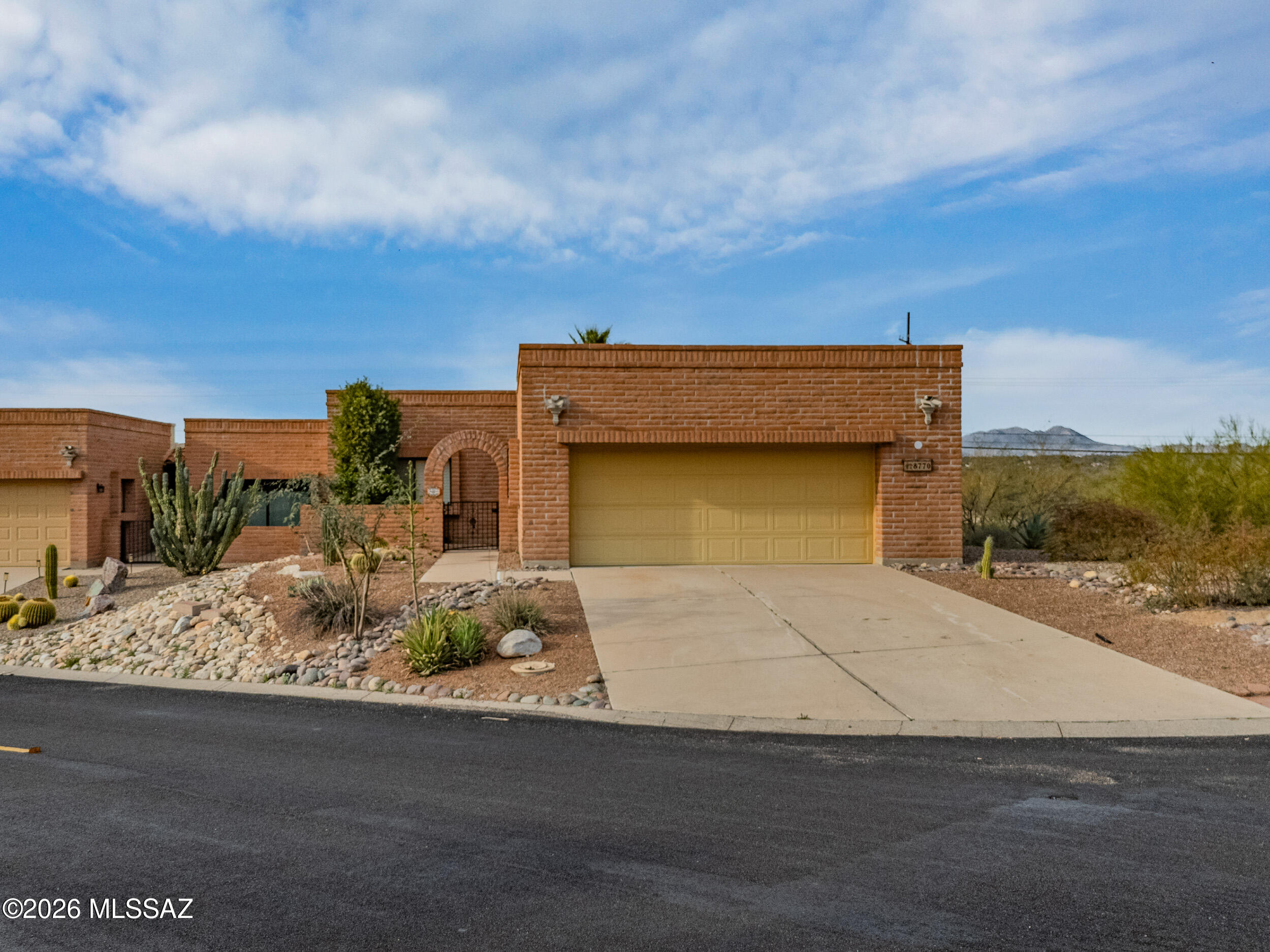 Welcome to this beautifully refreshed desert retreat in desirable northwest Tucson. This inviting home offers a bright, open living space anchored by a charming fireplace and seamless indoor-outdoor flow to a private patio—perfect for relaxing or entertaining. Recent updates include fresh interior and exterior paint, new carpet, modern lighting, updated fixtures, baseboards, switches, and added safety features throughout. The kitchen shines with new fixtures and lighting, while both bathrooms feature updated fixtures, mirrors, and toilets. Low-care desert landscaping enhances curb appeal and easy living. Set in a peaceful community with mountain views, this move-in-ready home blends comfort, style, and effortless Arizona living.