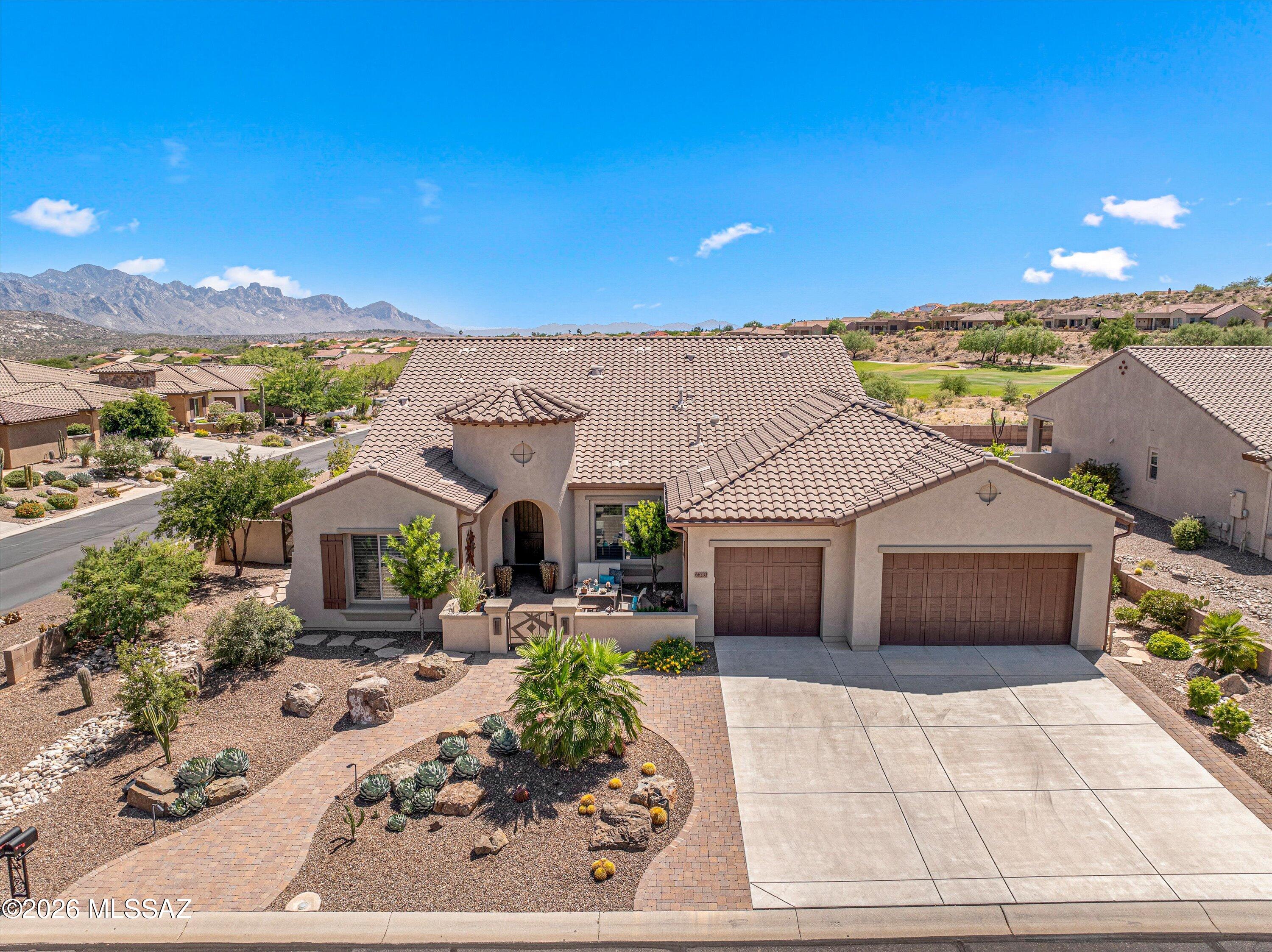 Welcome to your ultimate high-desert sanctuary in the premier active adult community of SaddleBrooke! Meticulously built in 2013, this impressive 2BD/2.5BA+Den+Bonus Room (2,635 sqft) single-story residence perfectly encapsulates contemporary desert luxury, offering extensive space, architectural refinement, and a highly functional layout. Step inside to be greeted by a beautifully light-filled interior, featuring an expansive open-concept great room layout with high ceilings and substantial picture windows that invite a flood of natural Arizona sunlight. The home's architectural flair provides distinct spaces for casual hosting and formal gathering alike. The chef-inspired kitchen stands as a central culinary hub, packed with premium cabinetry, sprawling workspaces, and a thoughtful configuration that looks out over the main living area. The primary owner's retreat serves as a true sanctuary, boasting private rear-facing windows, a generous walk-in closet, and a spa-like ensuite bath designed for absolute relaxation. If that isn't enough closet space, the third bedroom has been converted into a luxury walk in closet, with custom build ins and ample space for an expanding wardrobe. The guest bedroom with an ensuite bathroom is equally well-proportioned, ensuring absolute privacy for family, visitors, or a quiet work-from-home executive office space. Outdoor living is an absolute dream on the spacious lot. The deep covered rear patio frames a low-maintenance, professionally landscaped backyard oasis--offering a highly private buffer zone that is ideal for enjoying Tucson's famous colorful evening sunsets or stargazing under the clear desert skies. Complete with an attached multi-car garage, this home places you minutes from SaddleBrooke's world-class golf courses, fitness complexes, tennis courts, and vibrant social clubs!
