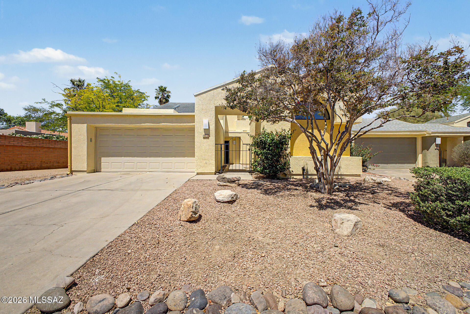 Ideally located in the coveted enclave of Bosque Creek within the historic Old Ft. Lowell District, this updated 1,921-square-foot single-family home offers a rare residential experience in Tucson. This unique property features three bedrooms and two bathrooms in the main house, complemented by a detached one-bedroom, one-bathroom casita, providing a total of four bedrooms and three baths. The interior is highlighted by soaring vaulted ceilings, wood-look flooring throughout, and numerous clerestory windows that flood the living spaces with abundant natural light. The eat-in kitchen is a chef's delight with quartz counters, stainless steel electric appliances, and a breakfast bar. The spacious primary suite serves as a true retreat with high ceilings, an oversized dual-sink vanity, a walk-in shower, a large walk-in closet, and private access to the outdoor yard space. A versatile upstairs flex space, which includes a private patio with stunning Catalina Mountain views, can easily serve as a bedroom, home office, or workout room. Modern comforts include central heating and air conditioning, full-size laundry, and a two-car garage. Residents can enjoy a private outdoor living area with mature landscaping or utilize the neighborhood hiking paths in the Bosque Creek Habitat Preserve leading to a secluded community pool. Perfectly situated near the Riverwalk, Tucson Medical Center, and local dining, this home considers dogs but maintains a no-cat policy.