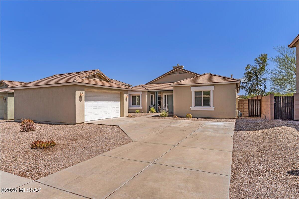 Rare opportunity on one of the few gated streets in Corona de Tucson! This beautifully maintained 3-bedroom, 2-bath home features a desirable split floor plan, spacious great room with a cozy gas fireplace, and a versatile front flex room perfect for a home office, den, or hobby space. The kitchen offers granite countertops and stainless steel appliances. Enjoy Arizona living in your private backyard oasis with a sparkling pool, spa, mountain views, and a large lot backing to common area for added privacy. Recent updates include fresh exterior paint, a 1-year-old HVAC system, and pool equipment replaced in 2023. Extended garage provides extra storage or workspace. Conveniently located near highly rated Vail schools, shopping, and outdoor recreation.