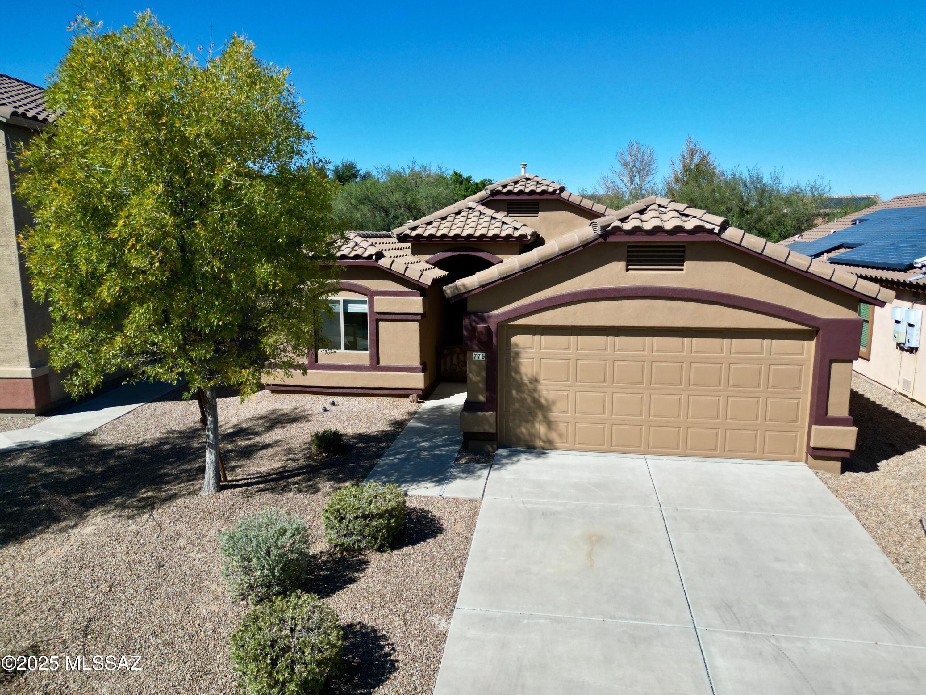 Discover effortless living in this beautifully updated 2-bedroom+den, 2-bath home in the coveted Rancho Sahuarita community. The versatile den easily converts to a third bedroom, giving you flexible space for a home office, gym or guest room. Freshly painted inside and out, the home greets you with brand-new carpet in the bedrooms and sleek tile flooring throughout the main living areas. The open-concept kitchen is a chef's delight, featuring abundant cabinet storage, a spacious pantry, and a seamless flow into the great room. Retreat to the primary suite, complete with dual vanities, a walk-in shower, and a generous walk-in closet. Outside, the covered back patio faces north, offering constant shade and comfort for year-round outdoor enjoyment. Just blocks away, you'll find the North satellite pool, community park, and scenic walking paths, making it easy to embrace the resort-style lifestyle Rancho Sahuarita is known for."