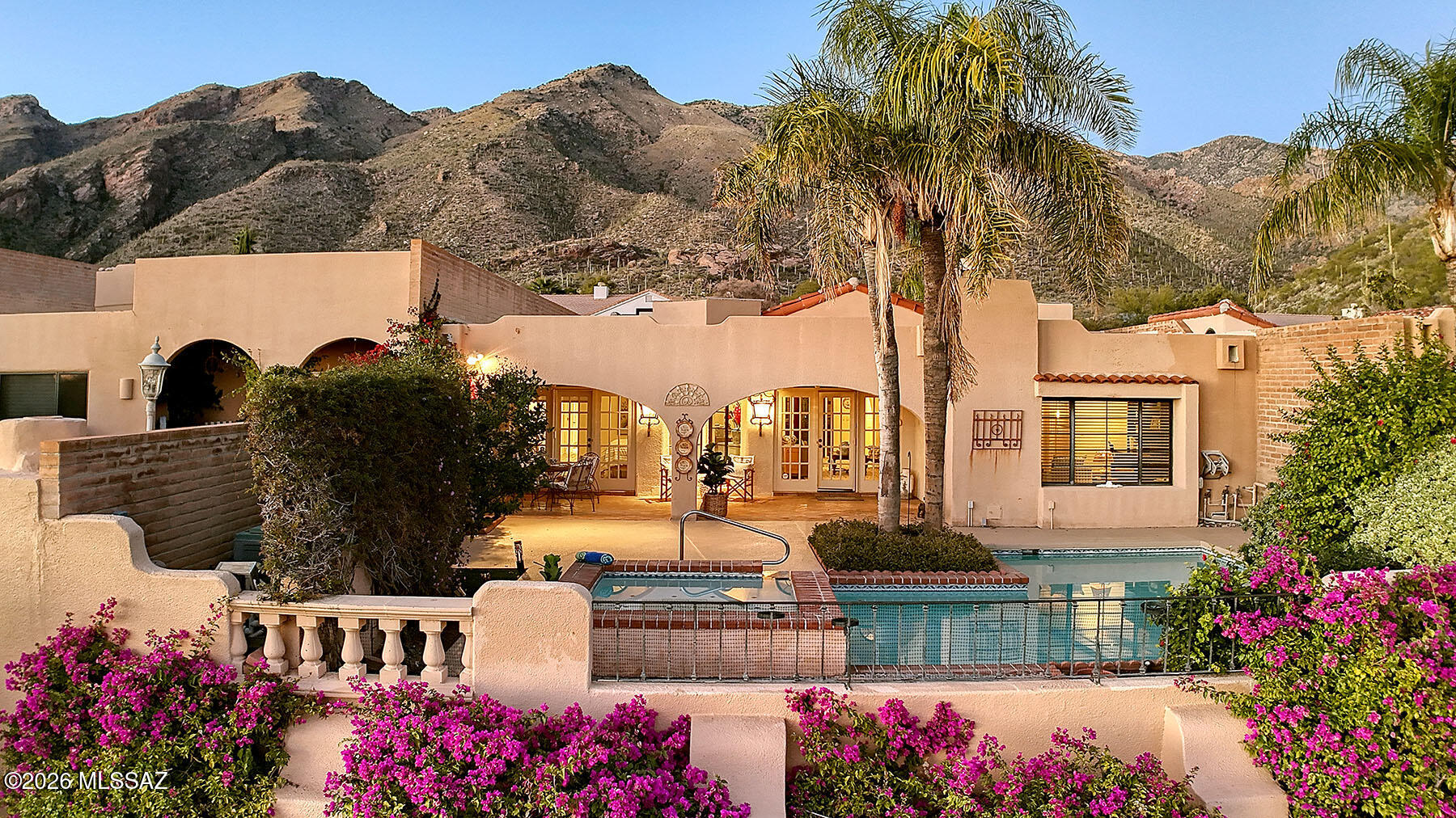 Sensational Arizona style townhouse with a private pool & Spa in prestigious manned gated Finisterra Estates. A lushly landscaped front gated courtyard with sparkling fountain invites you into this exceptional home with over 2965 sq ft. The spacious living area encompasses an exquisite Great Room with high vaulted ceilings, dramatic fireplace, French doors, Saltillo tile floors, formal dining room, spacious gourmet kitchen with granite countertops, stainless steel appliances, gas stove top, lovely breakfast area with walls of windows & Mountain views, 2 bedrooms plus office with built-in bookcases or 3 bedrooms, 2.5 baths including primary suite with French door entry to the rear patio,  large walk in closet, bath featuring dual sinks, garden tub & separate shower...... continued...... Enjoy the fabulous backyard with covered patio, pool, spa, built-in BBQ, lush landscaping & dramatic city views plus a community rec center with pool, spa & lighted tennis courts.