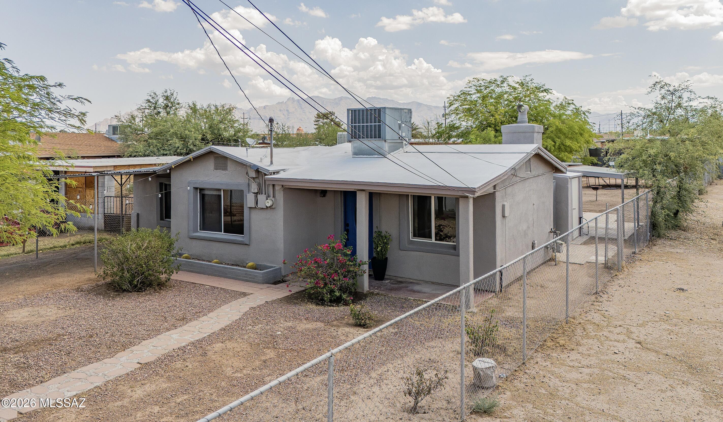 Beautifully updated 1952 bungalow with ranch-style floor plan. Enclosed .19 acre, R-2 lot. Ideal as a primary residence. Potential also for add'l building: multi-generational living, investment opportunities, addition of a guest house/casita, workshop, and more. Numerous electrical, plumbing, and lighting updates. Newly remodeled kitchen with closet pantry has all-new cabinetry, range and hood, granite countertops, stainless sink. All adjoin open dining/family room. Good storage with large hall closet and attached storage room. The neighboring historic El Rio Golf Course borders Hualpai Rd. 5-minute drive to the I-10. Also close to downtown, Pima College, the University of Arizona, The Loop, Mercado San Augustine, and more. This charming home awaits its new owner!