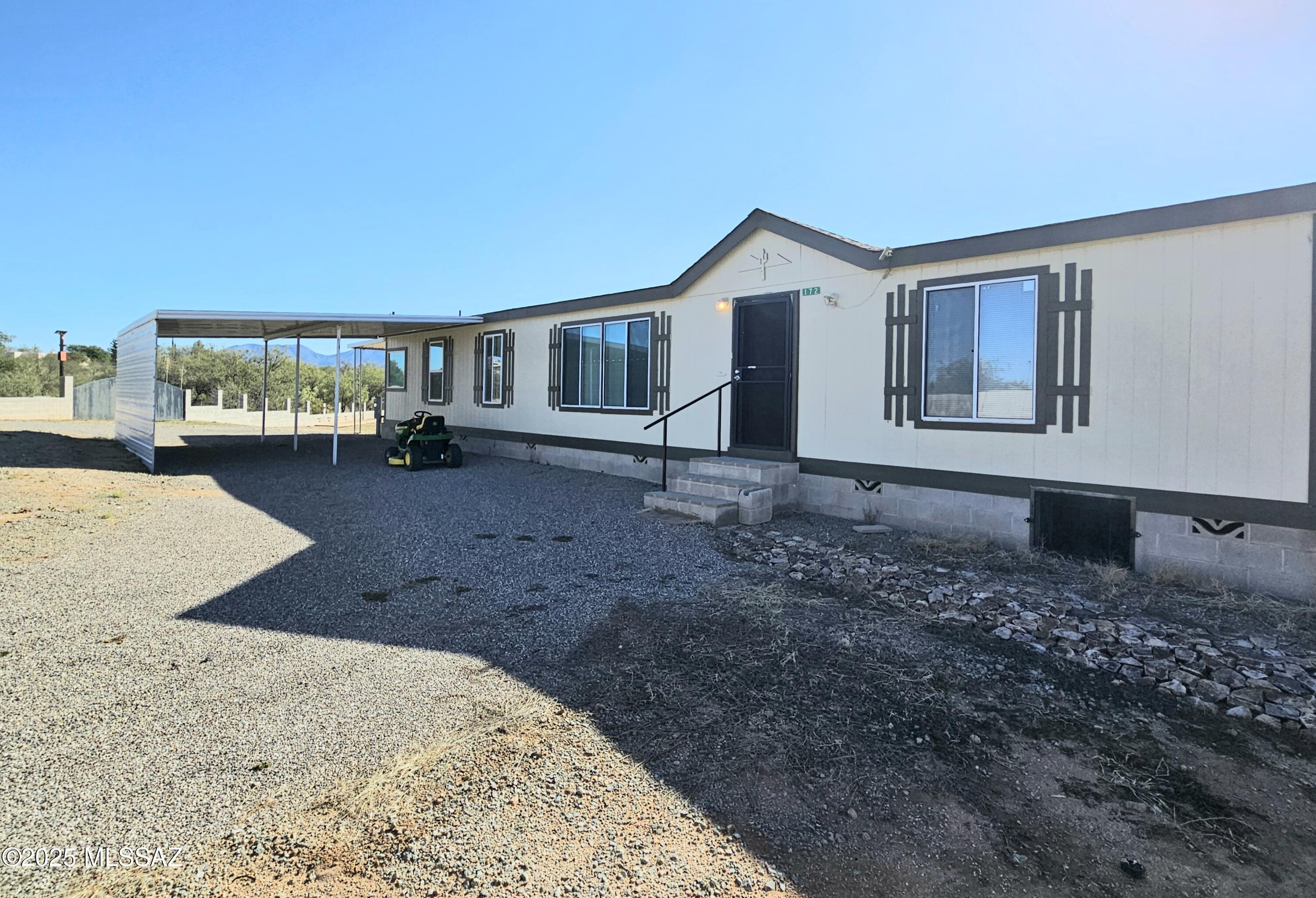 SELLER WILL CONSIDER OFFERS. Welcome home to this nicely remodeled 3 bed 2 bath plus a den/office, 1,736 sq. ft. country home right off of a paved road. Lightly lived in and move-in ready. Sitting on 1.12 acres zoned for horses. Fully enclosed property with a block wall w/double gate entry for larger vehicles. Beautiful mountain views. Bright and open floorplan with ceramic tile in main living areas, and carpet in the bedrooms. Lots of upgraded kitchen cabinets. Some furnishings may be purchased under a separate contract or be possibly included in the home sale with acceptable offer. 2 car carport. Newer roof under 5 years old.  Freshly painted interior and exterior. Private well. Easy access to I-10 for commuting. Come see this one today!