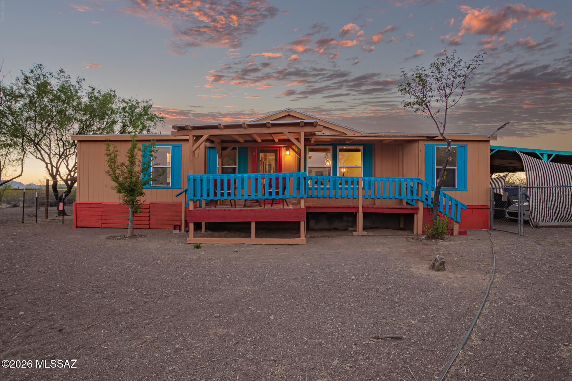 Welcome to your desert escape! This inviting and vibrant home is nestled on 4.14 acres at the end of a peaceful dead-end road, offering added privacy with a gated entry and fenced yard, all framed by mature desert trees that provide natural shade and tranquility. With expansive views and plenty of space to roam, this property is a true desert gem.
Inside and out, you'll find the perfect setting to relax and take in Arizona living--whether it's your morning coffee or evening unwind on the front or back decks overlooking the stunning Tucson mountain ranges. The seamless views from one deck to the other create an ideal flow for entertaining, all while soaking in the beauty of unforgettable sunrises and sunsets.
