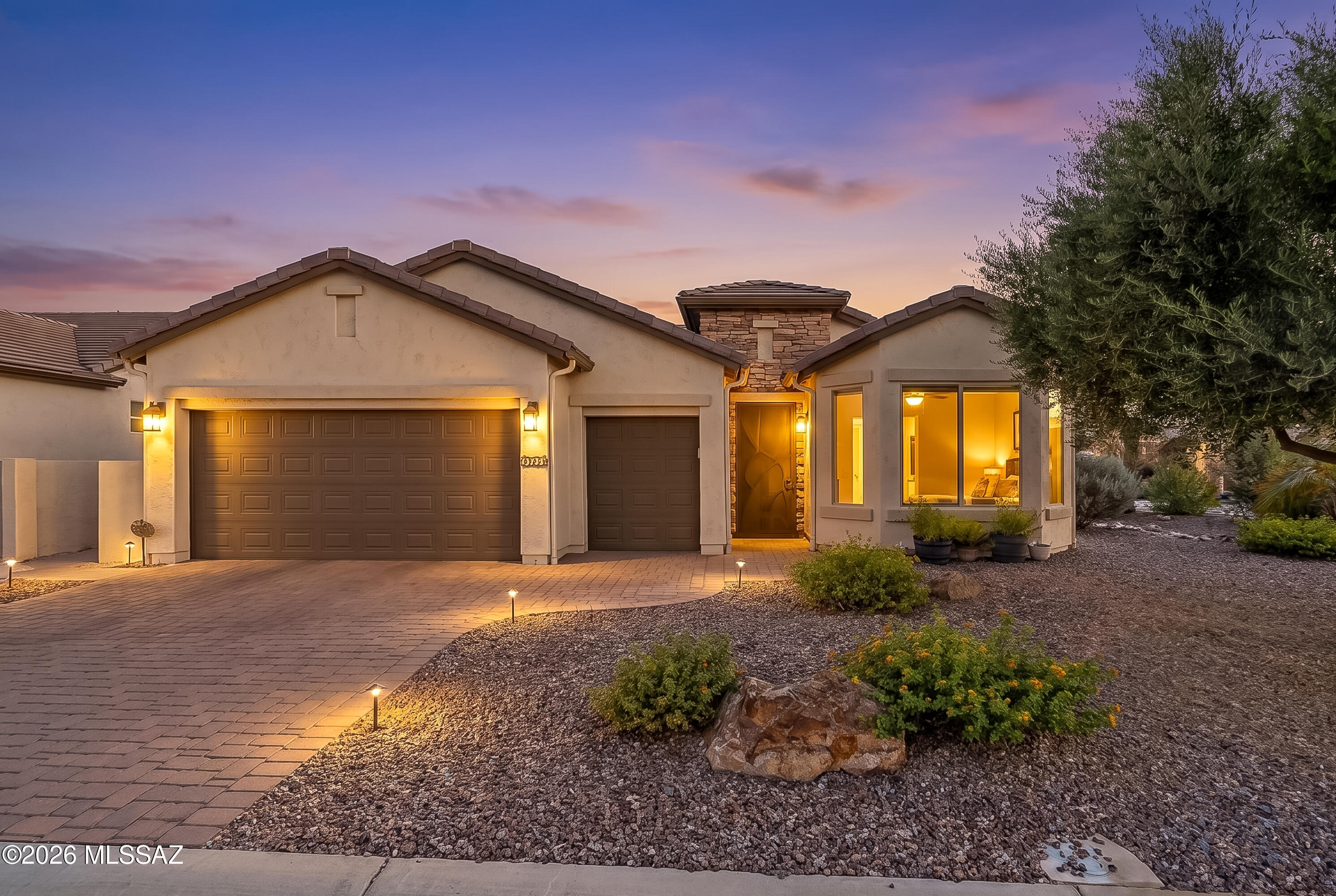 Modern Desert Living at Its Finest! Discover the perfect blend of contemporary style, thoughtful upgrades, and resort-inspired living in this beautifully appointed Dolce floor plan at SaddleBrooke Ranch. Perfectly situated on an oversized premium corner homesite with mature desert landscaping and peekaboo views of the Catalina Mountains and Mount Lemmon, this exceptional residence offers privacy, elegance, and an unbeatable location just moments from the community entrance and the Ranch House. From the moment you arrive, the professionally designed paver driveway, inviting courtyard entry, and striking curb appeal set the tone for the quality found throughout. Inside, an open-concept design is filled with natural light and showcases a sophisticated -inspired aesthetic that effortlessly blends modern elegance with everyday comfort. Sleek tile flooring flows throughout the main living areas, creating a seamless, low-maintenance living environment. The heart of the home is a designer-inspired gourmet kitchen that is both beautiful and functional. Rich espresso cabinetry is complemented by gleaming quartz countertops, a stunning designer tile backsplash, stainless steel appliances, under-cabinet lighting, contemporary pendant lighting, and an oversized center island that invites family and friends to gather. Carefully selected designer details--including a distinctive contemporary faucet with a vibrant splash of color--add warmth and personality while creating a kitchen that is as stylish as it is practical. The spacious owner's suite offers a peaceful retreat with abundant natural light and generous space to relax, while both bathrooms feature elegant walk-in showers, delivering a spa-like experience. The washer and dryer are included, making this home truly move-in ready. Step outside and enjoy Arizona living at its finest. The oversized corner homesite is beautifully landscaped with mature desert vegetation, offering exceptional curb appeal, added privacy, and relaxing peekaboo mountain views. The covered patio creates the perfect setting for morning coffee, outdoor dining, or simply enjoying the breathtaking Arizona sunsets. Car enthusiasts and golf lovers alike will appreciate the extended two-car garage with a dedicated golf cart garage, providing exceptional storage and convenience for embracing the SaddleBrooke Ranch lifestyle. Living in SaddleBrooke Ranch means enjoying one of Southern Arizona's premier active adult communities, featuring championship golf, resort-style pools, pickleball, tennis, a state-of-the-art fitness center, creative arts studios, exceptional dining, scenic walking trails, dog parks, and an endless calendar of clubs, events, and social activities. Beautifully maintained, thoughtfully upgraded, and ideally located, this exceptional Dolce floor plan offers the perfect combination of modern design, everyday comfort, and the vibrant Arizona lifestyle you've been waiting for. This is more than a home--it's your next chapter.