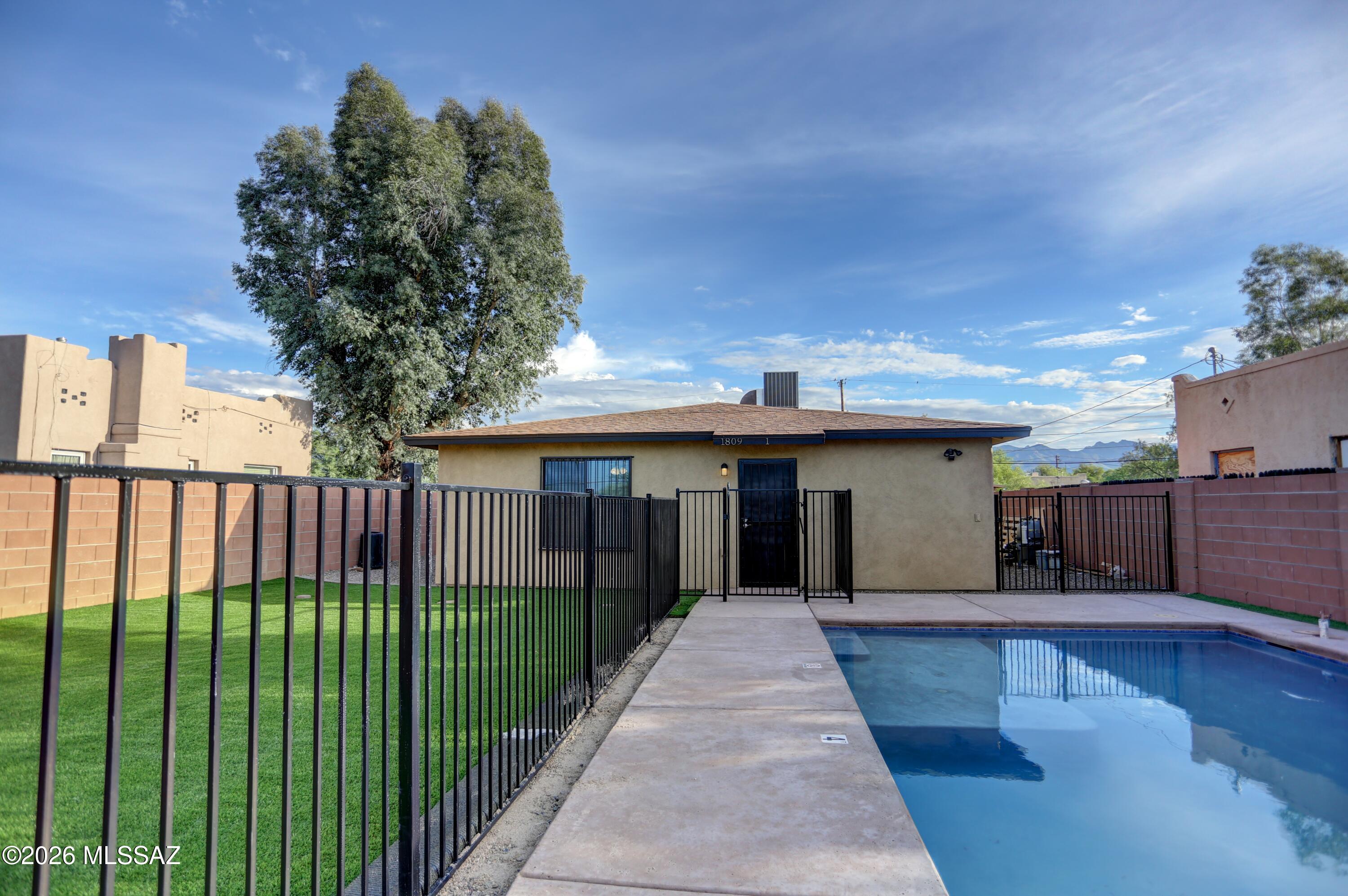 Now offered with a $50,000 price reduction. Investment opportunity with leases in place through July 2027. This duplex consists of two 4 bedroom, 2 bath units (8 bedrooms, 4 bathrooms total) located near the University of Arizona. Designed for student living, the property features spacious floor plans, a pool, turf covered outdoor entertaining area, privacy walls surrounding the yard, and on property parking. Each unit includes its own washer and dryer, and all appliances convey. Unit #2 has been recently updated with new paint, countertops, light fixtures, and remodeled showers. Please do not disturb tenants. Lease details available upon request.