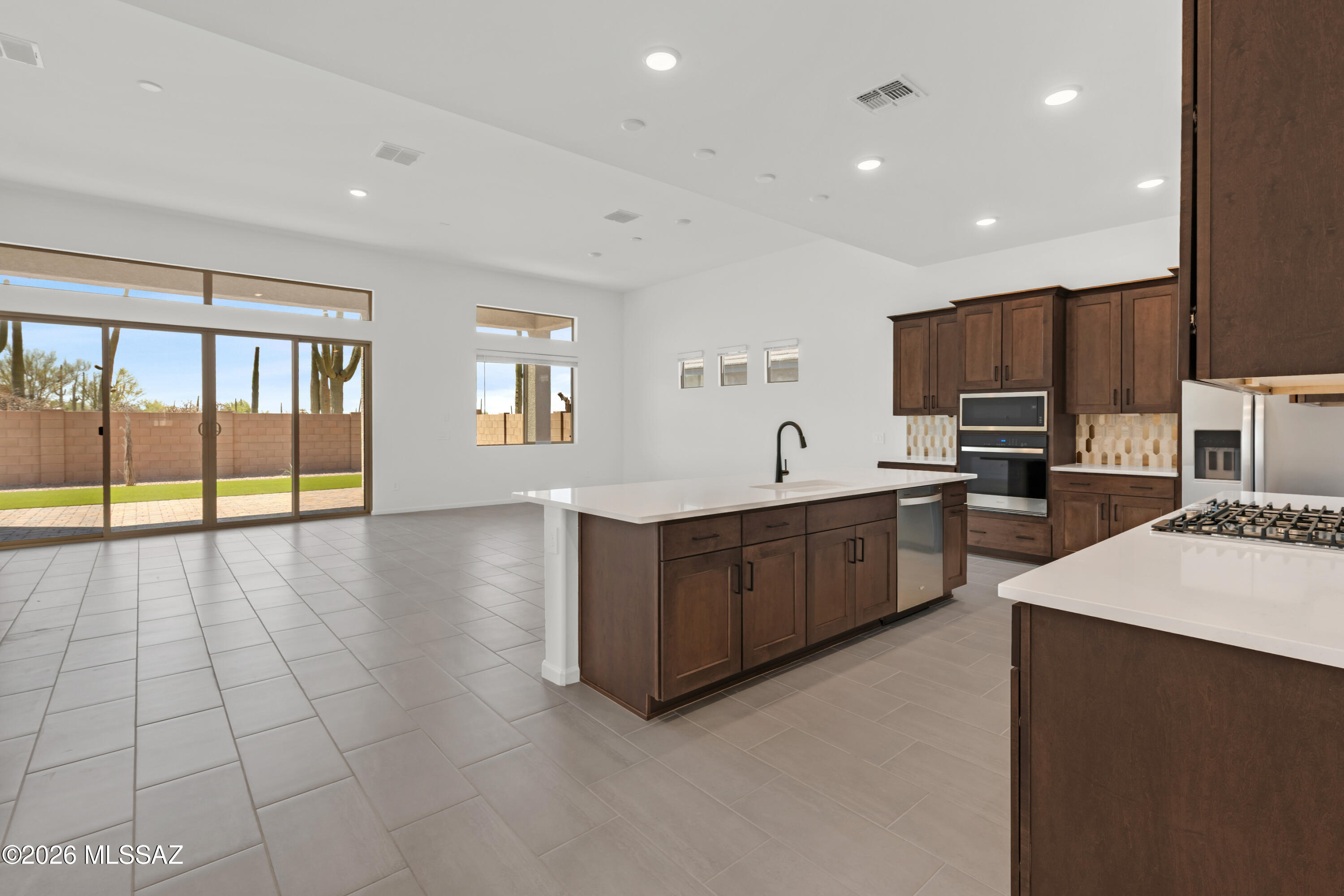 Beautiful Flint plan with Spanish elevation offers spacious elegance in an open Greatroom concept. Covered back patio, seamlessly blends indoor & outdoor living. Kitchen is a chef's delight, featuring quartz counters, gas cooktop, Whirlpool refrigerator, center island & walk-in pantry. 3-car tandem garage provides ample space for vehicles & storage. The Owner's suite exudes luxury with generous walk-in closet with direct access to laundry room, walk-in shower, & extended vanity with dual sinks. Welcome home to comfort & contemporary living. Includes: , 10' ceilings, Washer/Dryer, & faux wood blinds.