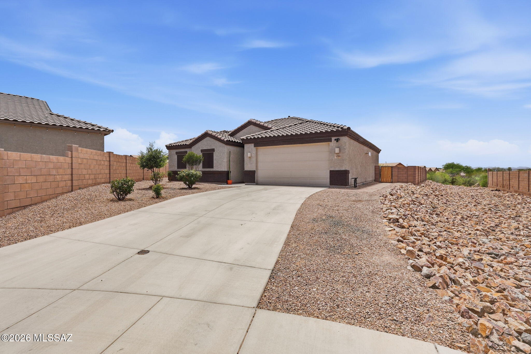 Welcome to this beautiful Single-Story home tucked away in a quiet Cul-de-Sac in desirable Vail, AZ. This pristine home is like new offers 3 bedrooms, 2 bathrooms and a Spacious Split floor plan for both privacy and functionality. White kitchen w granite counter tops and stainless-steel appliances, walk in pantry and working island perfect for everyday living. The spacious primary suite w his & hers closets, dual vanity and walk in shower. Enjoy Arizona living with the low maintenance backyard with paver patio, exterior window shade screens and stunning mountain views, extended driveway & 2 car garage for ample parking and storage space. This Corona de Tucson property is a must see! Highly desirable location! beautifully maintained, move in ready moder comfort, a functional floor plan and an exceptional setting. This single-story home features a desirable split floor plan with 3 bedrooms, 2 bathrooms, providing added privacy and comfortable living spaces. The spacious primary suite offers a private retreat with two walk-in closets, providing generous storage and plenty of room to stay organized. The open concept great room creates a welcoming atmosphere complemented by modern finishes gas appliances and gas heating. Tucked away on a private cul-de-sac with wider streets and beautiful mountain views. Step outside, landscaped backyard featuring paver patio, solar shades installed throughout the home to help reduce heat and improve energy efficiency. This is a wonderful opportunity to own a pristine, move in ready home in Corona de Tucson.