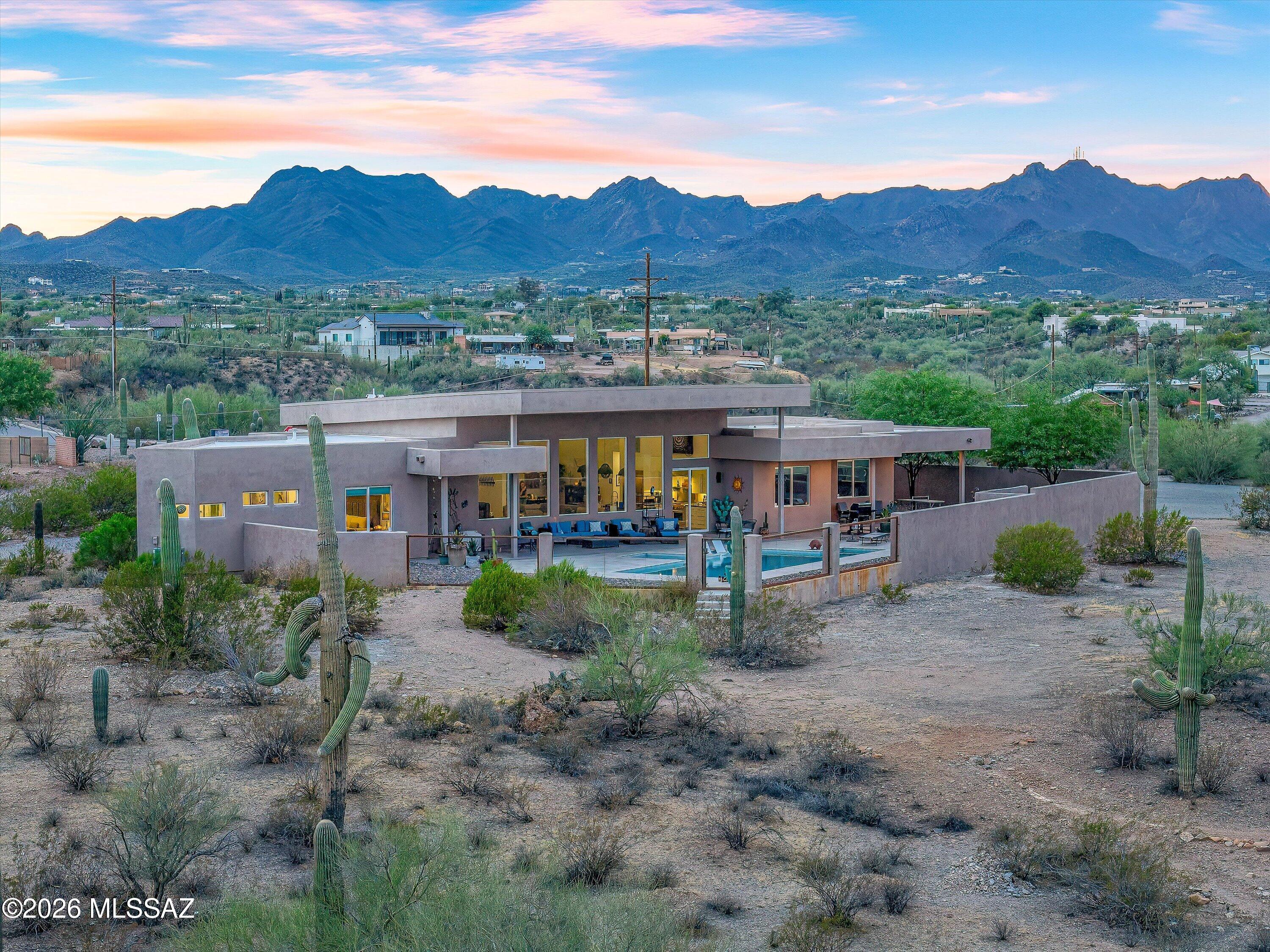 **Range Priced: Sellers will accept/counter offers between $999,999-$1,295,000** Wake up each day to the beauty of exceptional desert living in this stunning 3-bedroom/3-bath custom home where every square inch has been meticulously designed with comfort, style, & functionality in mind. Perfectly positioned to capture breathtaking views of all 4 surrounding mountain ranges - Catalinas, Rincons, Santa Ritas, & Tucson Mountains - this immaculately maintained home offers a seamless blend of modern elegance & natural beauty.
The impressive split-bedroom floor plan provides privacy & flexibility, while concrete floors throughout create a sophisticated, contemporary aesthetic. At the center of the home you'll find a chef's kitchen purposefully created to impress, featuring high-end finishes, generous workspace, & an ideal layout for entertaining. Masterfully designed to embrace Tucson's indoor/outdoor lifestyle, this exquisite property offers more than 2,000 sq ft of covered outdoor living space, creating the perfect setting for entertaining, relaxing, & enjoying the gorgeous desert scenery. Step outside to your private backyard retreat, where a heated 40-foot pool invites year-round enjoyment against a backdrop of spectacular views. Adjacent to a nature preserve, the property offers a rare sense of tranquility, privacy, & connection to the surrounding landscape.
Additional highlights include two laundry rooms, spacious living areas filled with abundant natural light, & extraordinary attention to detail throughout. The spacious 3-car garage is equipped with two EV fast chargers, while ample additional outdoor parking provides plenty of room for guests, recreational vehicles, & outdoor toys--so bring the RV. Located just minutes from downtown & I-10, this remarkable home combines luxury, convenience, & unparalleled desert views in one unforgettable package.