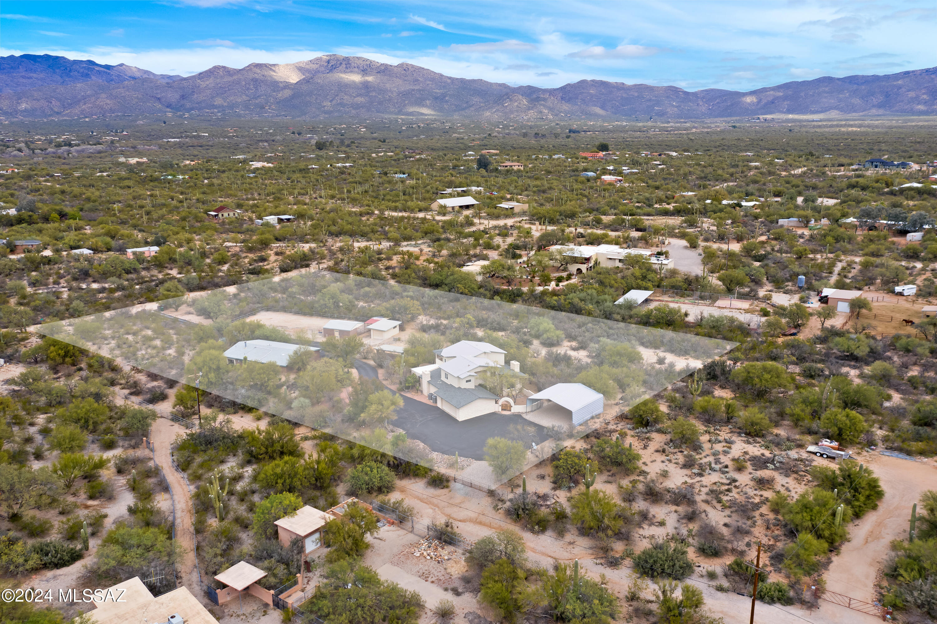 Two homes on 3.6 acres nestled at the base of Saguaro National Park East in ''the notch''. Horse property with majestic views of Catalina Mountains. 2926 sq ft main house features 4BR/3.5BA/2 Car garage, wood beam ceilings, kitchen with maple wood cabinetry, granite counters, built in desk. 2 Fireplaces, large master suite with entrance onto view deck. Perfect for outdoor entertaining. Flagstone patio, firepit, seating areas. Separately metered 2BR/1BA 1199 sq ft detached private guest house w/4 car tandem garage. Approx 30' x 30' covered RV shelter, 60 x 150 arena with predator proof fencing. Large backroom, 3 covered stalls, 12 x 20 workshop (1 car garage), covered hay storage. 2 blocks tp dog friendly trail in Saguaro National Park . Set back from 5th street for peace and quiet.