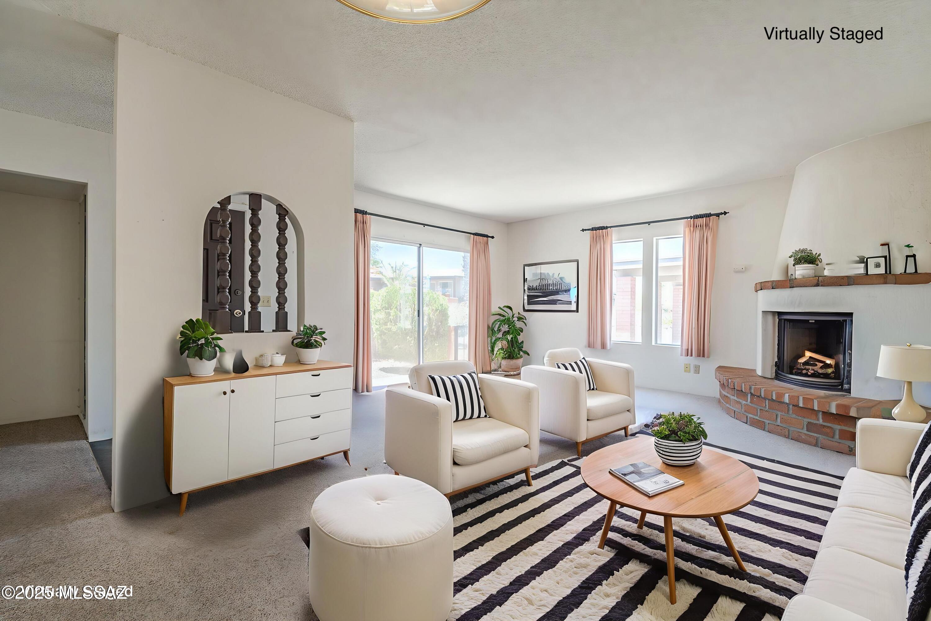 Fresh Opportunity in the Heart of Green Valley! This charming end-unit townhouse offers the perfect blend of comfort, convenience, and potential. Whether you're searching for a seasonal retreat, full-time residence, or investment property, this home is ready for its next chapter. Step inside to a bright and inviting living room featuring a classic beehive gas fireplace that creates a warm focal point for relaxing evenings. The home has been freshly cleaned, including the carpets, providing a move-in-ready space with the opportunity to personalize it to your own style. The kitchen opens seamlessly to a covered patio with a pergola--an ideal spot to enjoy your morning coffee, unwind with a good book, or entertain friends. The spacious primary suite offers private patio access through a sliding glass door, creating a peaceful retreat to enjoy Arizona's beautiful weather. Additional highlights include a new HVAC system installed in 2023, Roof Recently re-coated, a detached covered carport, and a desirable end-unit location for added privacy. Conveniently located just minutes from shopping, restaurants, medical facilities, and the community pool, this home also includes access to Green Valley Recreation, offering numerous recreation centers, swimming pools, fitness facilities, pickleball and tennis courts, clubs, classes, and year-round social activities. With an attractive price that leaves room for your personal updates and vision, this is an excellent opportunity to own an affordable home in one of Green Valley's most active and welcoming communities.