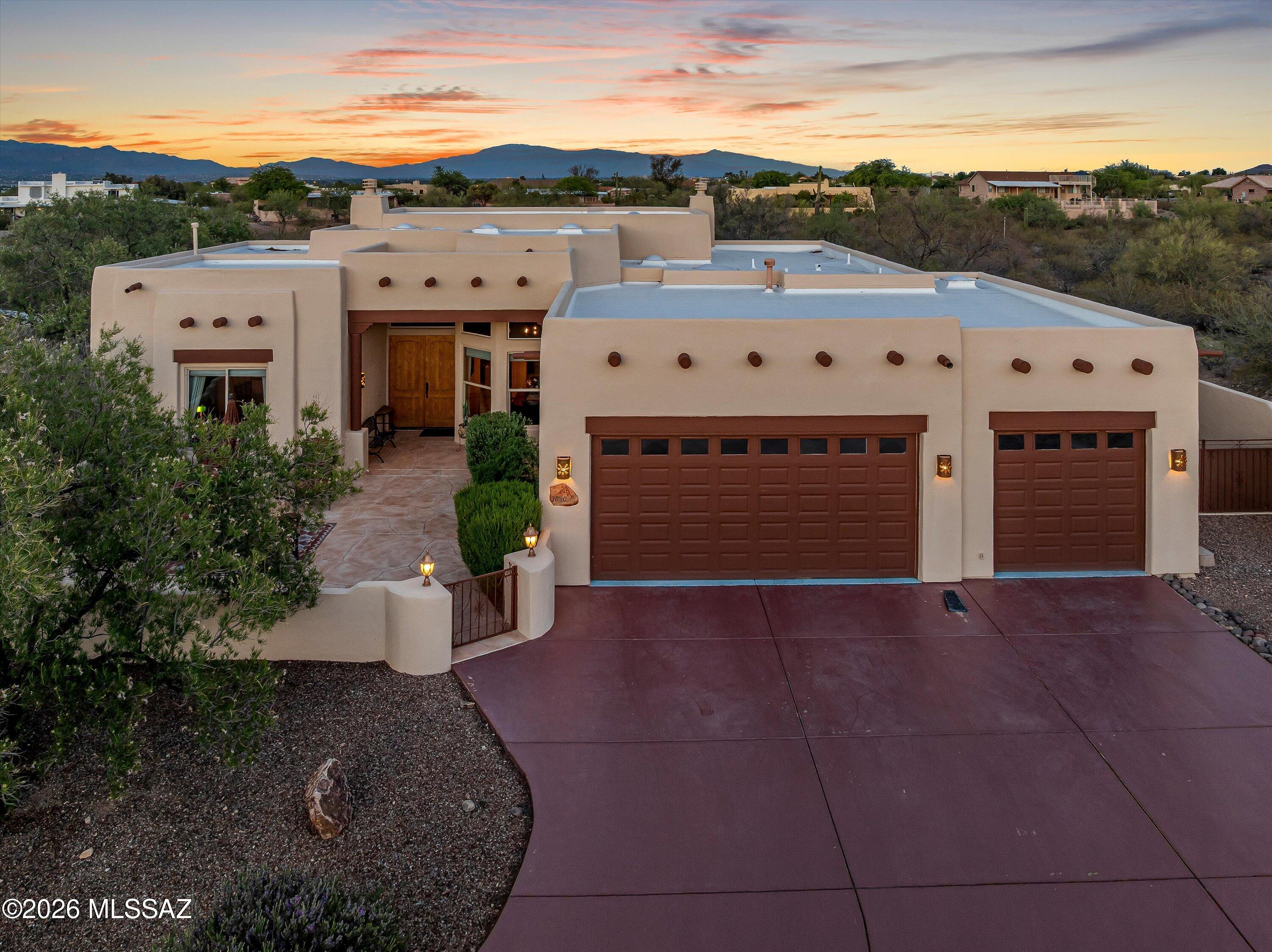 Experience the essence of Southern Arizona living in this beautifully designed home. Enter through the inviting private courtyard into a residence rich with warmth and architectural detail, Soaring ceilings & a stunning great room w/ exposed wood beams creates an open, airy feel. The 4th bedroom offers flexibility for an office/den. 8-ft solid wood doors throughout add a touch of craftsmanship. Expansive windows frame sweeping views of Tucson & the majestic Catalina Mountains, bring the beauty of the desert landscape indoors. Situated on a generous 1.35 - acre offering both space & privacy. Enjoy large covered patio in backyard. The extra-deep three-car garage provides ample room for vehicles, storage, or recreational toys. Meticulously maintained. Located in intimate gated community.