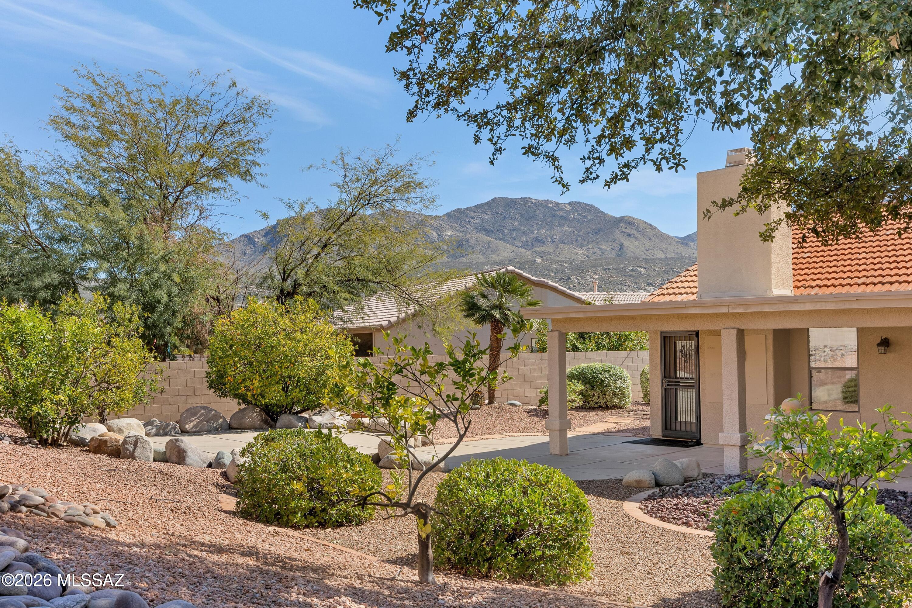 Lovely Topaz with Private Yard! Roof Underlayment Replaced 1/2026. Enter into living room & dining area. Family room with gas fireplace & slider to patio. Kitchen offers granite counters, stainless appliances, pantry, custom soft-close cabinetry & drawers, plus kitchen dining area with desk. Owner's Suite has patio slider & ensuite bath with dual vanity, walk-in shower, & custom organized walk-in closet. Den/Office with accordion door for privacy. Guest bedroom with walk-in closet & nearby guest bath. Built with 2x6 construction. Laundry room with w/d & cabinets. Extended 2-car garage has newer HVAC, water softener, sink, cabinets, & insulated garage door. Enjoy the private gated yard with covered patio, pergola at owner's suite, lovely landscaping, & 8 fruit trees-perfect for Arizona!