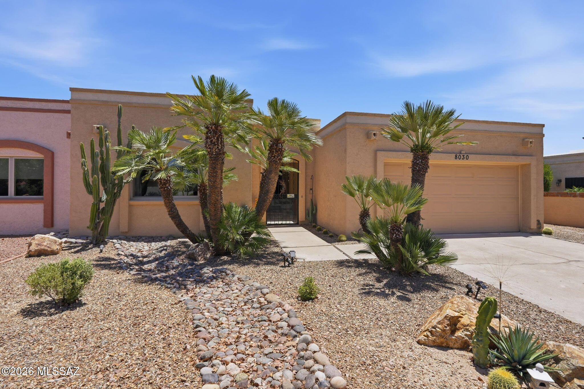 Nestled within the coveted Casas Del Oro Norte community at Tucson National, this beautifully remodeled single level townhome blends timeless Southwest elegance with modern comfort. Thoughtfully updated in 2021, the home welcomes you with rich travertine flooring, a spacious great room with a stylish fireplace and sweeping views that frame the golf course and surrounding mountains.

No thought was spared in the design of the gourmet kitchen. This chef inspired space features abundant drawer cabinetry that keeps everything within easy reach, stunning rich cabinetry, granite counters, stainless appliances, an induction cooktop and a wraparound island that offers exceptional prep space and the perfect setting for entertaining. It is truly a dream kitchen for anyone who loves to cook or host.

The open layout offers effortless flow with no interior steps and tasteful accessibility features that enhance everyday living. The primary suite provides a calming retreat with a walk in closet and a beautifully appointed bath. Outdoors, the private low care yard borders the natural wash and enjoys no rear neighbors, creating a peaceful setting with desert plantings, decorative gravel and uninterrupted views.

Located in a quiet gated 55 plus enclave known for its history, lush landscape and warm community feel, residents enjoy access to a heated pool, spa, walking paths and a charming bird sanctuary. With direct access to the LOOP, the Omni Resort, the YMCA and the nearby library, this home offers a rare blend of convenience, tranquility and refined desert living.