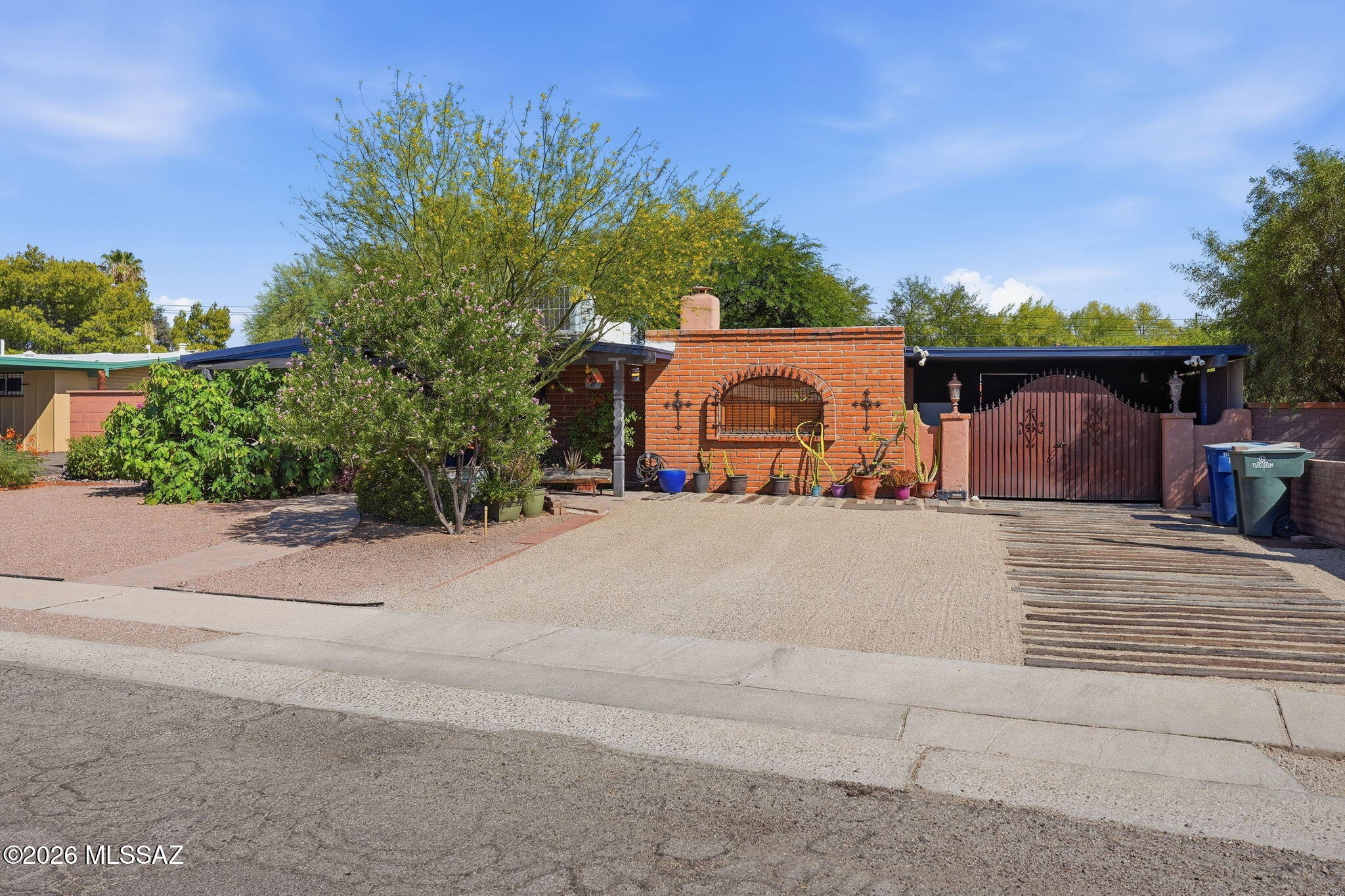Authentic Mexican American-style brick home (inside and out), formerly owned by a Grammy Award-winning musician, featuring 4 bedrooms and 3 baths with numerous custom additions. Spacious layout includes an expanded living room, private master suite wing, office nook, exercise nook, and laundry nook. Guest baths feature a Jacuzzi tub and large walk-in shower, while the master bath offers a dual-head walk-in shower and room-sized walk-in closet. The oversized master bedroom includes a built-in electric fireplace. Enjoy a creative kitchen, covered porch, gazebo, outdoor spa, lounging deck, finished creative trailer/studio space, and large storage shed. The divided backyard offers privacy and flexible use for entertaining, gardening, pets, or future customization.