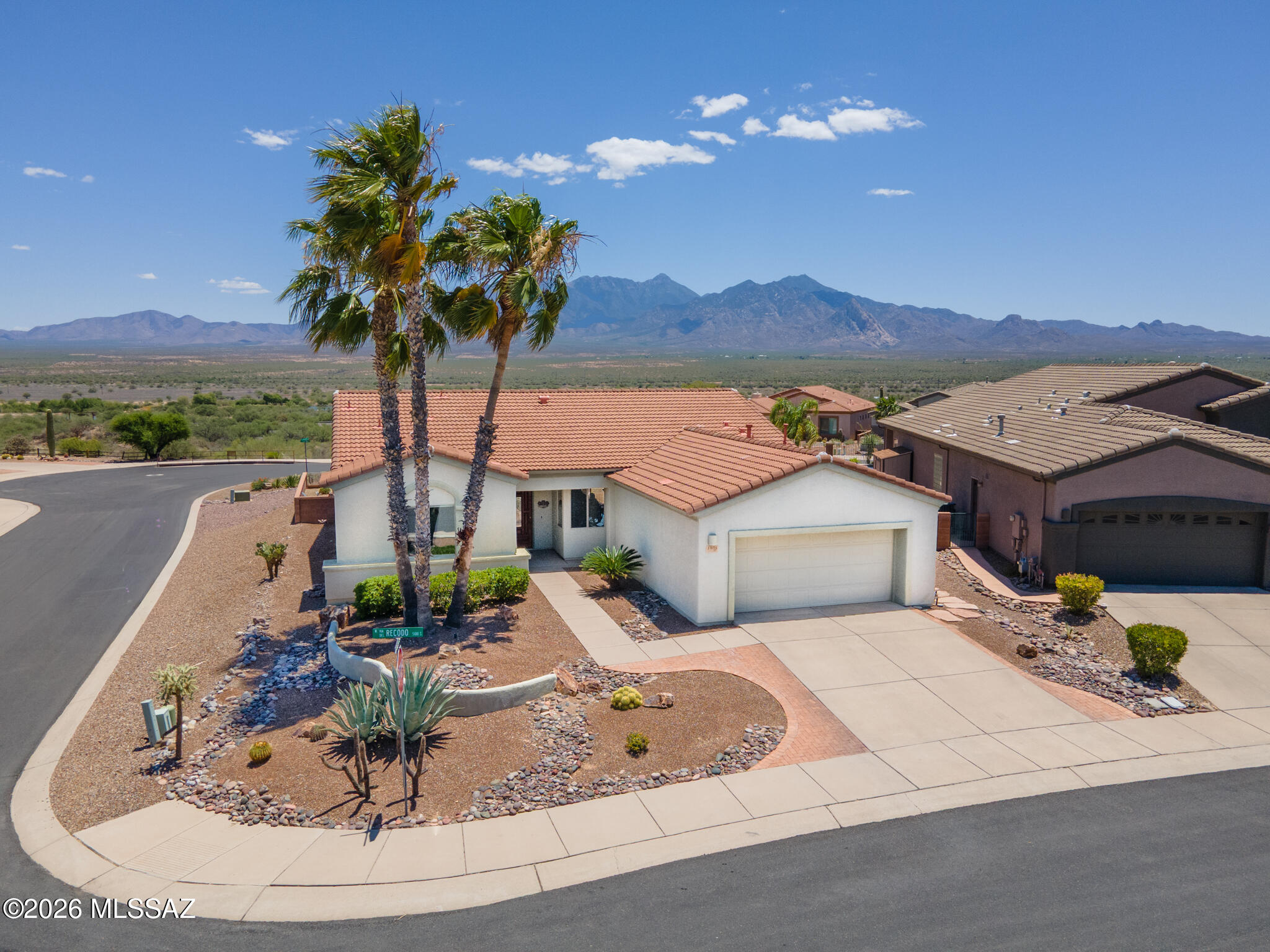 Discover refined desert living in this 1,775 sq ft 2-bed + den home on a premium ¼-acre lot with unobstructed mountain and valley views. Enjoy a light, open layout with tile floors, custom paint,  cherry cabinets, Silestone counters, roll-outs with newer range, refrigerator, dishwasher, and washer. The den features built-ins and a coffered ceiling; the owner's suite offers a bay window and upgraded primary bath. Wait till you see the shower! Extended laundry/hobby room and oversized garage with workbench, storage, and cedar closet. Outdoors, relax under the covered patio pergola and upgraded paver patio, with thr peaceful waterfall, ideal for entertaining with stunning views. Located in a quiet, well-loved 55+ Green Valley community with full GVR amenities nearby.