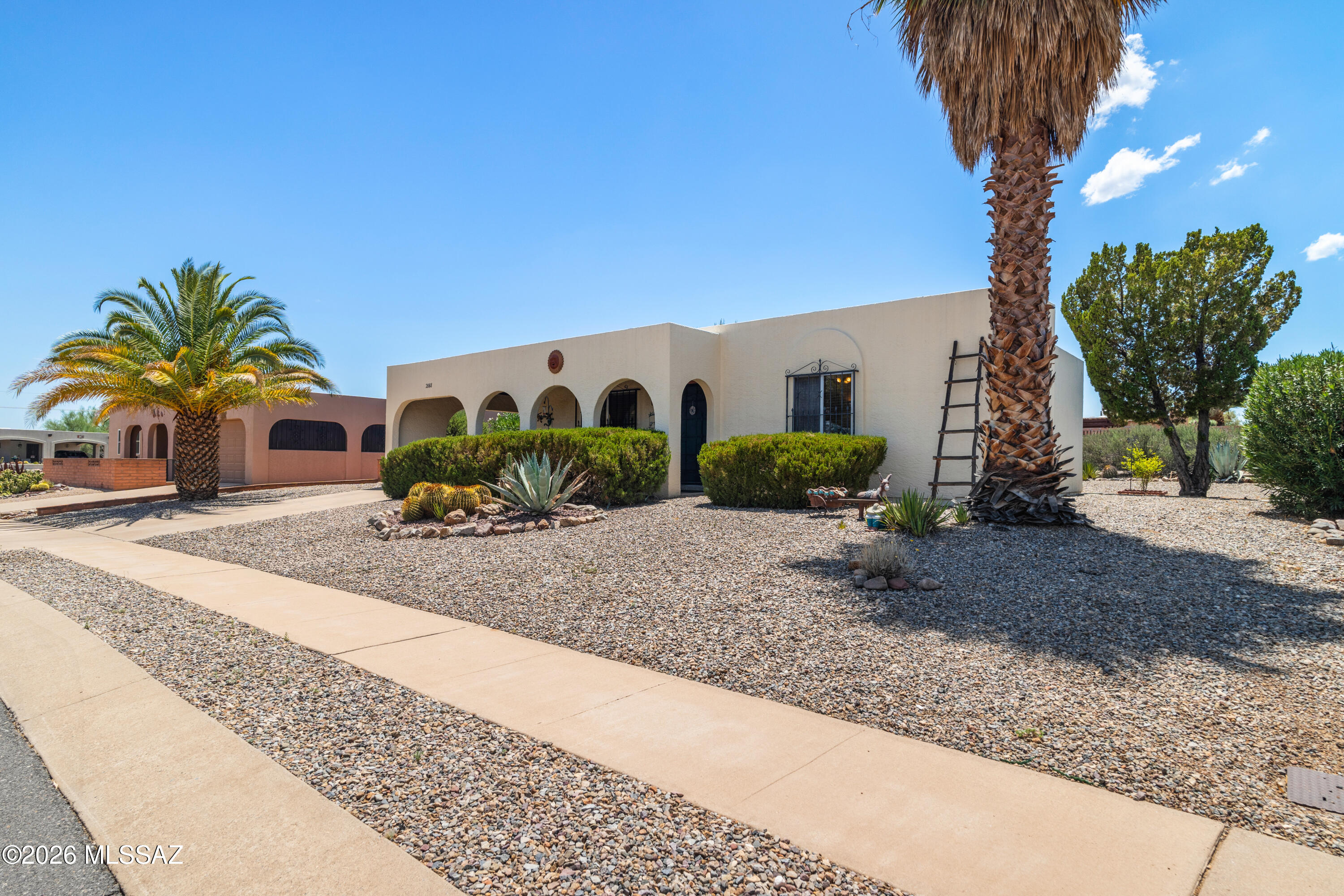 This lovely southwestern style home is well maintained and move in ready. The kitchen has been nicely upgraded with appliances, granite counter tops, and a water purifier. The laundry room and work shop are in a separate building and this bonus space frees up living area inside the home. 
The walled back patio has a relaxing water feature. This shaded outdoor space is great for entertaining family and friends.
This Green Valley location provides a beautiful mountain view to the east.
