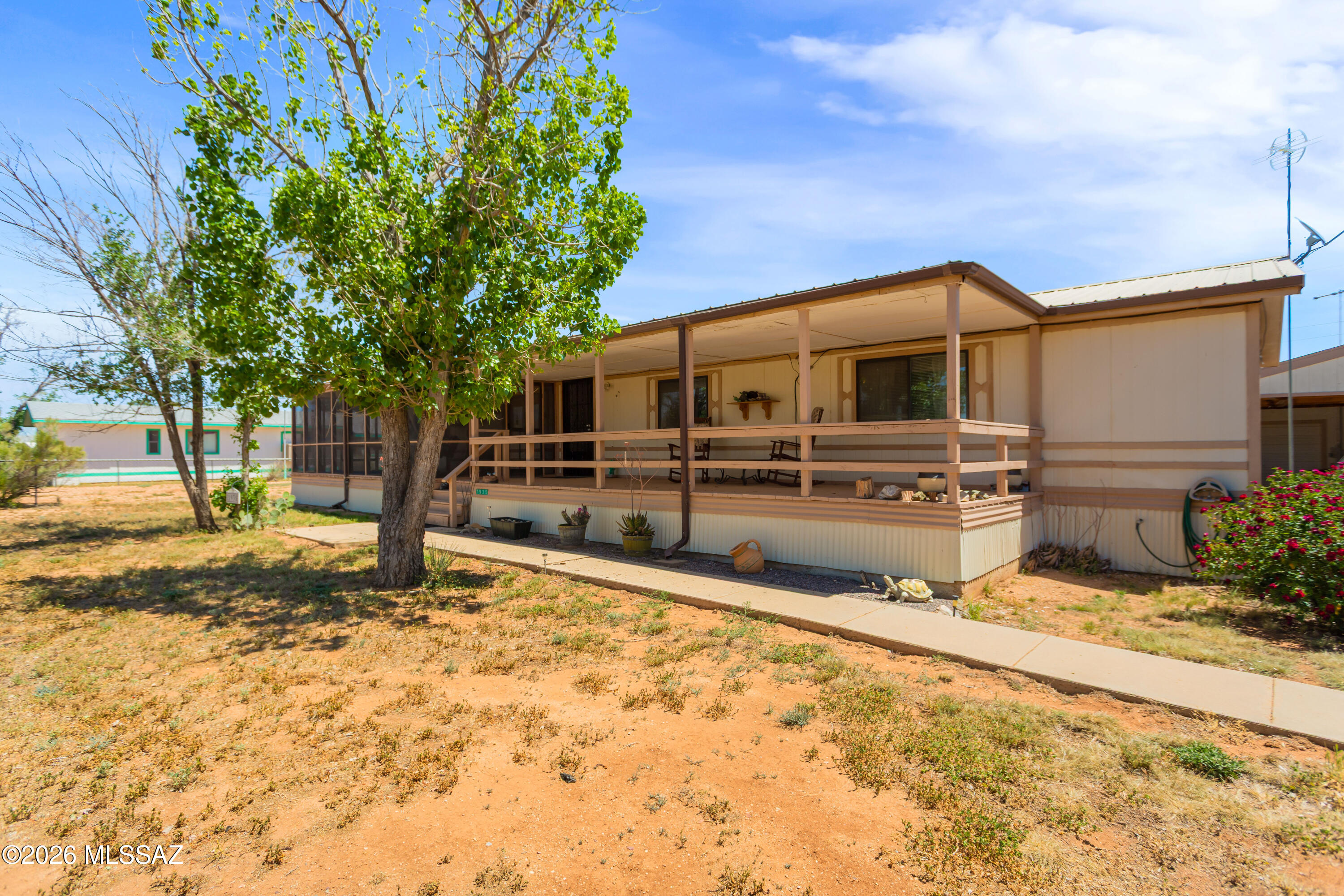 Discover the potential in this partially remodeled home, ready for your finishing touches to make it your own. Recent upgrades include new subflooring with durable vinyl flooring throughout, updated plumbing, and a new AC unit.  This property features three covered patios, including one screened-in. The Arizona room includes its own wall-unit cooler, along with a large built-in craft or hobby table.
The home also includes a 2-car garage, providing ample space for vehicles, storage, or a workshop. Situated on two lots totaling nearly half an acre.
Located in a peaceful neighborhood with newly paved roads, this home combines rural charm with a convenient 20-minute drive to Benson. A great opportunity for buyers looking to personalize a home with solid upgrades already in place.