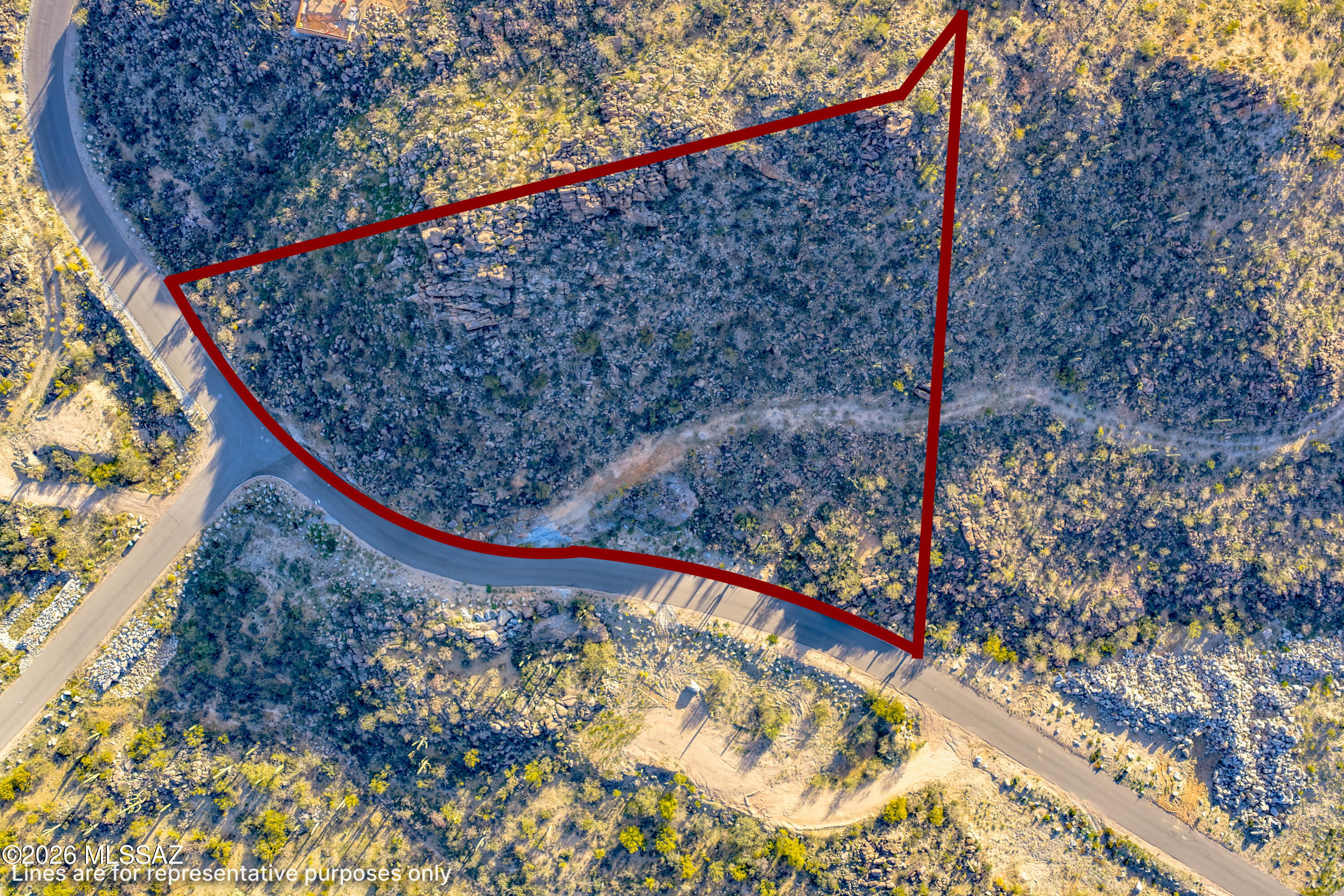 Located in the gated Saguaro Ranch community, this 2.36-acre homesite in Moonlight Canyon offers a scenic desert setting with natural vegetation, rock features, and open mountain views. The parcel provides generous space for a custom home while maintaining privacy and the character of the surrounding Sonoran landscape. Saguaro Ranch is known for its distinctive tunnel entrance and its location in North Tucson between the Stone Canyon and Dove Mountain areas. An opportunity to build within a unique desert community surrounded by protected open space and dramatic terrain.Loc