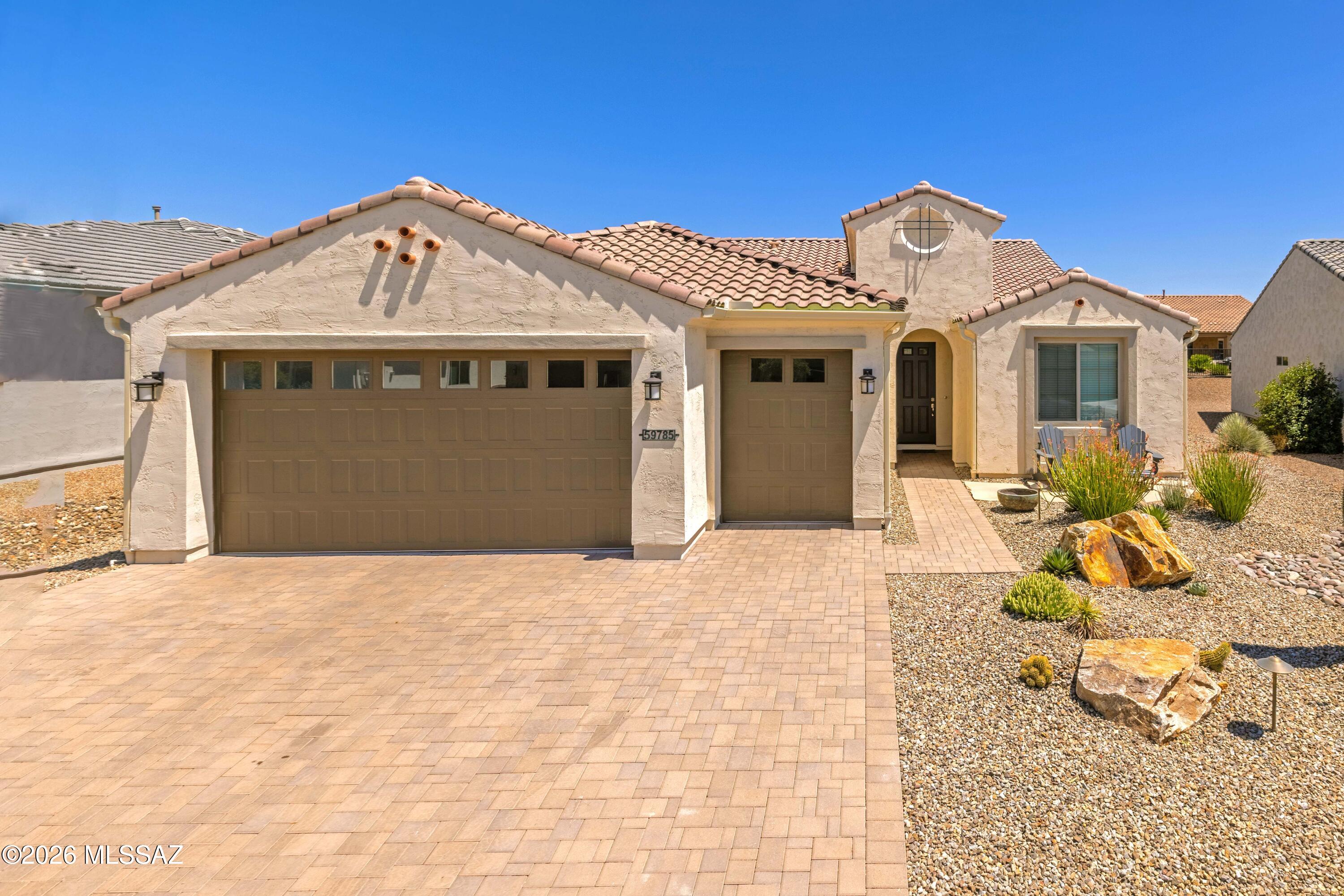 This Bella model in SaddleBrooke Ranch is one you won't want to miss -- single owner and it shows. The open layout flows beautifully with tile flooring throughout the main living areas and a kitchen that was clearly built with cooking in mind. Quartz countertops, upgraded cabinetry, a gas cooktop, and stainless LG appliances that all stay make this one truly move-in ready. The bar area with its wine fridge and sink is a nice bonus for entertaining.
Out back is where this home really separates itself. All done in 2026 -- a full outdoor kitchen, oversized pergola, extended paver patio, and new iron and stucco fencing give the backyard a polished, resort-like feel that's hard to find at this price point. The garage is a standout too. Extended four feet, golf cart bay, utility sink, and a water softener already in place -- exactly what Ranch buyers are looking for.
Inside, the master bath features a makeup vanity, blinds are throughout the home, and the den offers flexible space for a home office or guest room. The home is vacant and the sellers are out of state -- easy to show and ready to go.
Come experience everything SaddleBrooke Ranch has to offer -- golf, pickleball, pools, fitness, and a community that truly delivers on the active adult lifestyle.