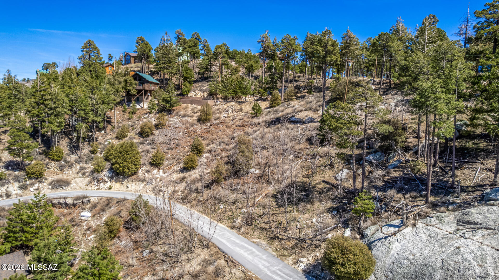 3 Elevated Parcels Totaling 0.42 of an Acre in Summerhaven. This is a great value! Combine into one expansive homesite! It captures truly stunning, unobstructed west-facing views of Summerhaven and the surrounding mountain ranges. From sunrise to sunset, take in sweeping panoramas of rolling hills, rugged rock formations, and endless desert horizons that create a breathtaking natural backdrop. The property offers a sense of privacy while still being accessible via a paved, winding road. The varied topography allows for a custom build that takes full advantage of the views. Includes 3 parcels (APNs: 205-14-4990, 205-14-4980, 205-14-4970) totaling approximately 0.42 acres (buyer to verify). Parcels are being sold together and are intended to be merged.