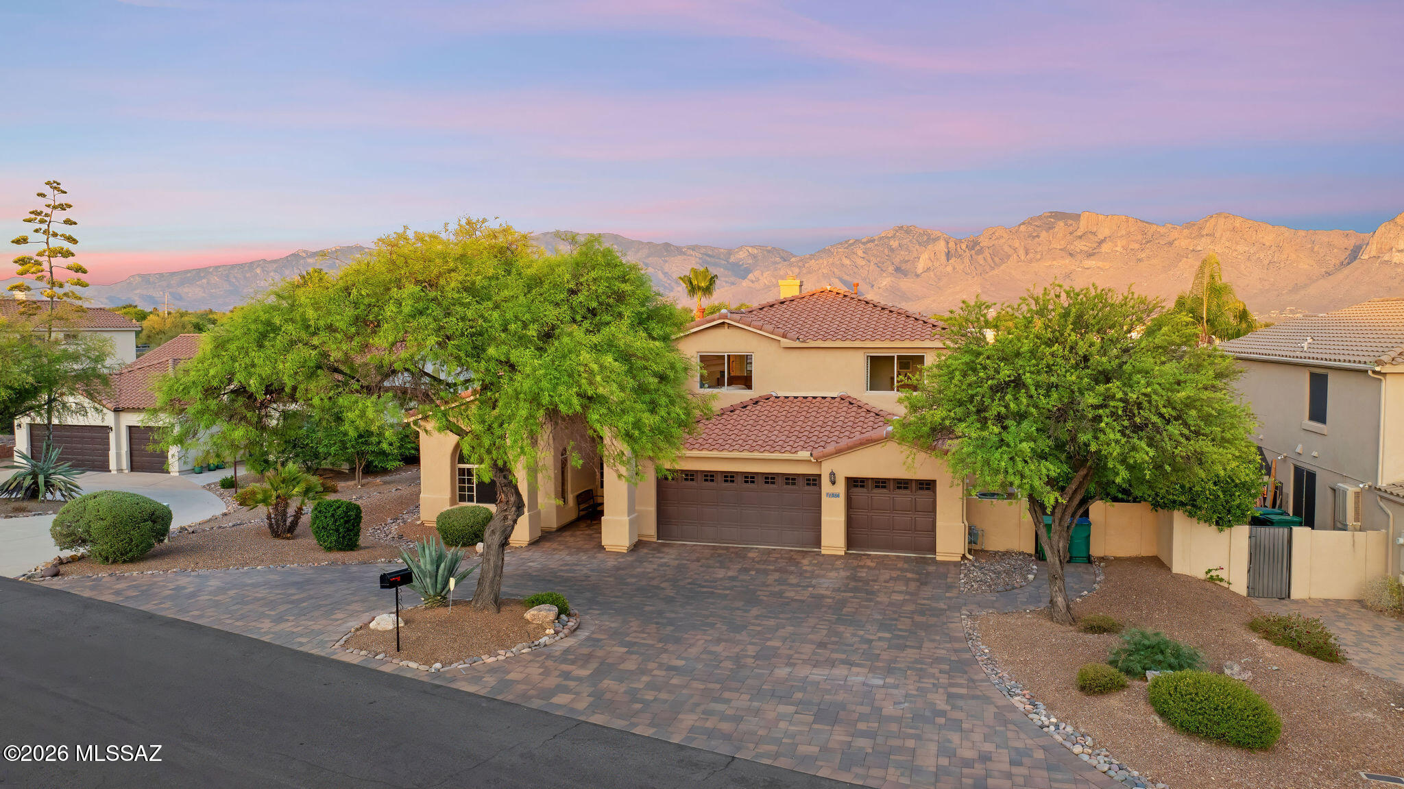 Experience the very best of Oro Valley living in this stunning desert retreat, perfectly positioned against a backdrop of protected natural desert and breathtaking Pusch Ridge mountain views!

Designed for both relaxation and entertaining, the backyard feels like a private resort. Enjoy a sparkling pool and elevated spa, expansive patio areas, mature desert landscaping, and uninterrupted mountain vistas that create an unforgettable setting from sunrise to sunset! The outdoor living space is exceptional, featuring a covered lounge with a stone fireplace, television, and multiple seating areas, along with a built-in outdoor kitchen ideal for year-round Arizona entertaining! Inside, soaring ceilings and expansive windows fill the home with natural light while framing beautiful desert views. The spacious open-concept floor plan flows effortlessly between living, dining, and kitchen spaces, creating an inviting environment for everyday living and hosting guests alike. The kitchen offers abundant cabinetry, generous prep space, a center island, and seamless connectivity to the home's main gathering areas!

Recent improvements provide peace of mind and added value, including a newer roof, newer HVAC systems, a beautifully upgraded paver driveway with integrated lighting, a new front entry door, and refreshed pool decking. Don't miss the downstairs primary bedroom! Pride of ownership abounds here!

Situated in one of Oro Valley's most desirable locations, this home combines privacy, views, and thoughtful updates with convenient access to shopping, dining, golf, hiking trails, and top-rated schools!

Rarely does a property offer this combination of mountain views, resort-style outdoor living, and move-in-ready condition. This is Arizona living at its finest!