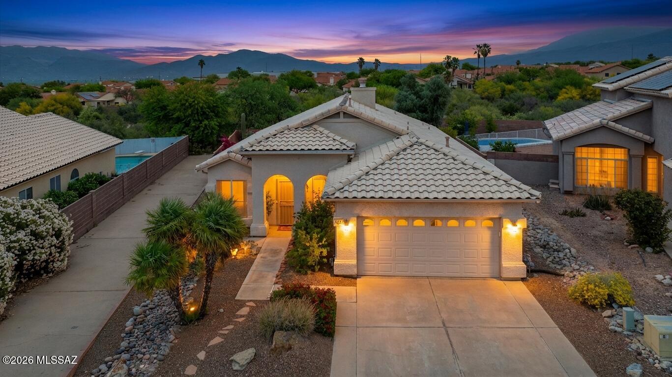 Enjoy your first cup of coffee gazing at Thimble Peak from the family room, breakfast table, patio, or even from your bed!  This home has amazing views of the mountains and is very open and spacious, complimented by cathedral ceilings and ceramic tile floors that flow throughout. The kitchen boasts granite countertops, marble backsplashes, and a butcher block island. Primary bath has garden tub, gorgeous tiled shower, and a generous walk in closet. Ceiling fans in all rooms and on back patio for relaxing and/or entertaining. All new interior paint, including cabinets and doors. Newer roof and AC. Large lot with huge backyard and manicured landscape on automatic water system. Very private with a wash and no homes located behind the property. The ideal blend of beauty and comfort.  VIEWS!