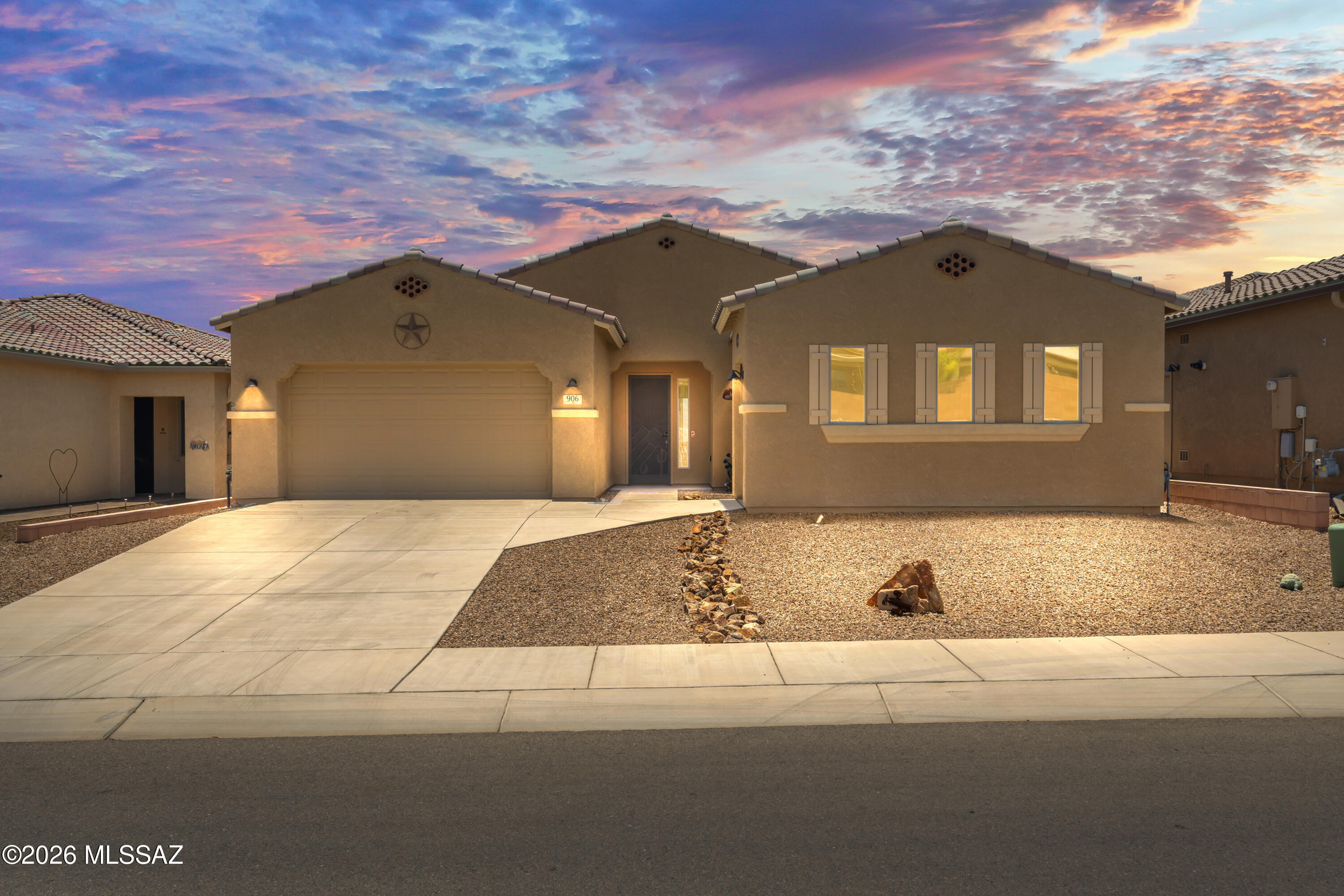 Better than new and built in 2021, this beautifully upgraded home offers beautiful mountain views and breathtaking sunrise vistas. With approximately $40,000 in enhancements, every detail has been thoughtfully designed for comfort, style, and functionality. A decorative security door welcomes you into an open, light-filled floor plan featuring soaring ceilings, tall 4-hinge doors, and tile flooring throughout most of the home, with carpet only in the guest bedroom. The spacious living area showcases a large bank of windows that frame the stunning views, along with ceiling speakers, ceiling fans, and remote-controlled shades for the sliding glass door. The chef's kitchen features quartz countertops, a large island accented by three elegant white pendant lights, pull-out cabinet shelving, a gas range, and a newer stainless-steel refrigerator. Offering 2 bedrooms plus a den, this home provides flexible living space for work, hobbies, or guests. The primary suite includes private patio access through a sliding glass door and an extra-large walk-in closet. Both full bathrooms feature granite countertops, and a convenient powder room is appointed with a pedestal sink.
Step outside to an oversized backyard designed for relaxation and entertaining. Enjoy mountain views from the patio, unwind in the hot tub, and appreciate the landscape featuring pavers, decorative rock, landscape lighting, and an elevated rear wall for added privacy. Additional highlights include a 3-car garage with epoxy floors and overhead storage, plus a tankless water heater for energy-efficient living. This exceptional home combines modern construction, premium upgrades, and unforgettable views in one outstanding package.