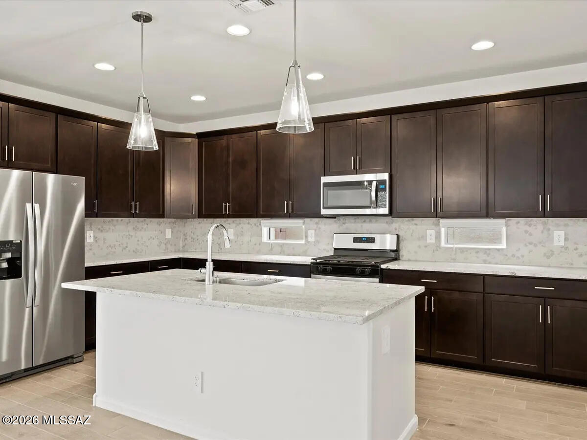Brand new, energy-efficient home available by Jan 2026! Open layout that includes a spacious kitchen with island and a great room that leads to a covered patio. Enjoy umber cabinets with shaded grey granite countertops, wood-look tile flooring and warm neutral carpet in our Elemental package. Located less than 10 minutes from I-10, it offers convenient access to employment centers and downtown Tucson. This community features several amenities such as bike and walking trails and playgrounds. Move-in ready with a washer, dryer, fridge, and whole-home blinds; closing in 60 days or less - guaranteed. Each of our homes is built with innovative,
energy-efficient features designed to help you enjoy more savings, better health, real comfort and peace of mind.