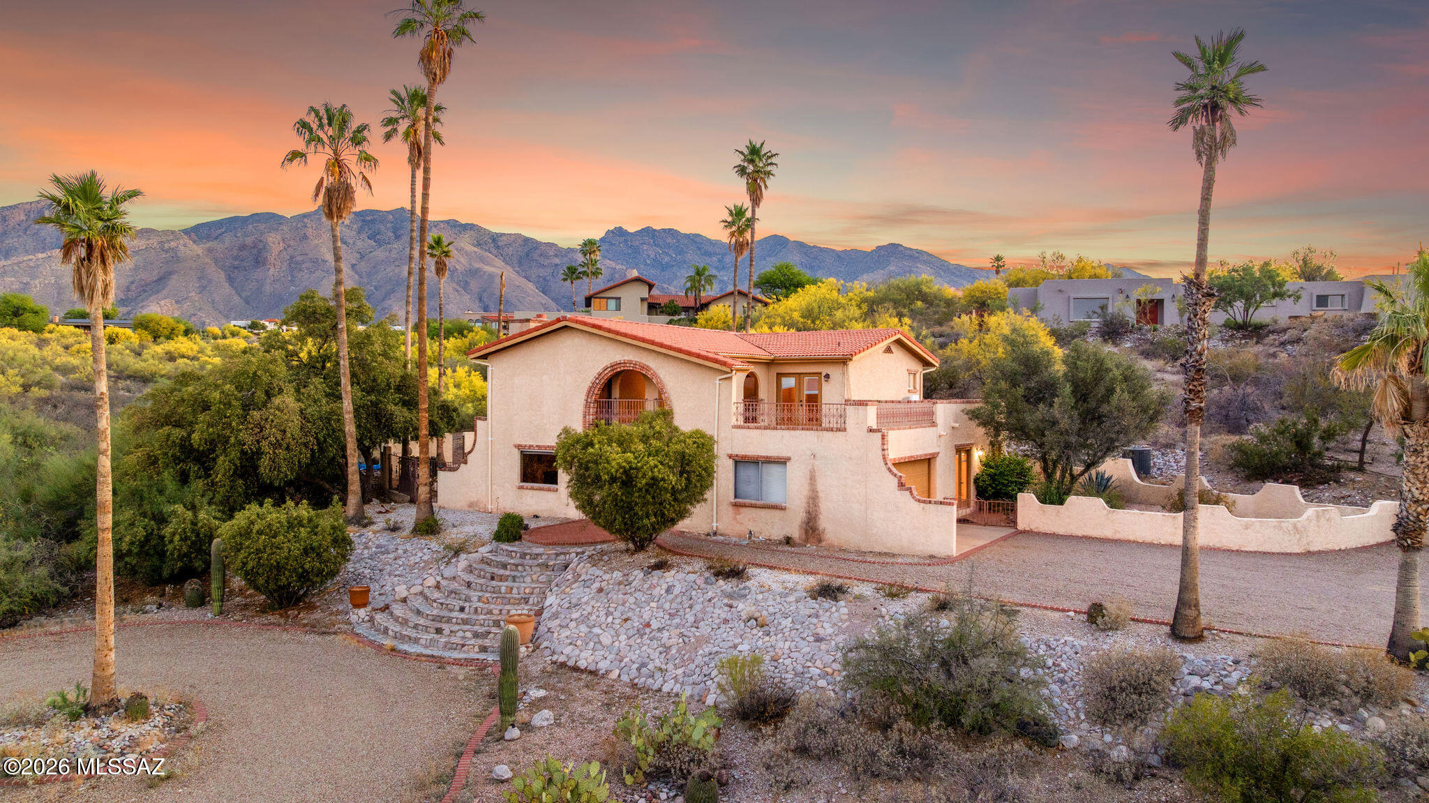 Nestled in the heart of the Foothills, this Old World Mediterranean style home sits on 1.14 acres of beautifully landscaped grounds blended with natural desert surroundings. Enjoy breathtaking Catalina Mountain views by day and sparkling city lights by night. Thoughtfully renovated in 2017, the home features travertine flooring throughout, with Berber carpet in three bedrooms. The fourth bedroom, ideal as a guest suite or office, includes travertine flooring and a private bathroom. Rich cherry wood cabinetry is showcased throughout the home and is complemented by premium Cabernet granite countertops. Additional highlights include dual cooling systems, stainless steel appliances, masonry construction, and a classic mission tile roof. Located within the highly sought after District 16 school boundary and free from HOA restrictions. The spacious resort style pool and entertainment area offers stunning mountain and city views, creating the perfect setting for relaxation and entertaining.