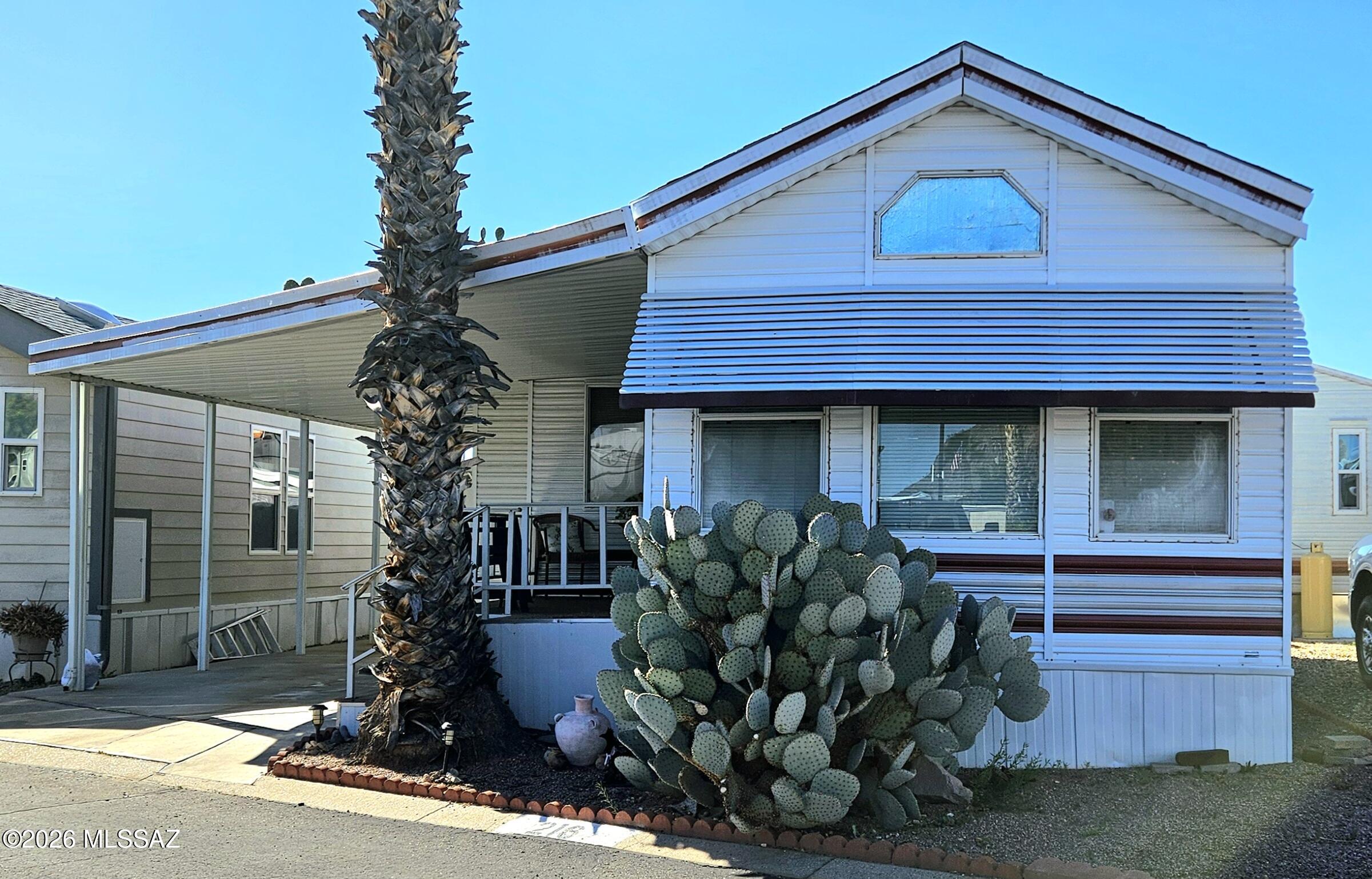 This 2 bed/ 1 bath home is in the Western Way RV Resort community, offering low maintenance living and access to fantastic amenities. This is a Vibrant active adult community. This 444 sq ft residence features a bright great room, a kitchen with electric range, refrigerator, and lots of cabinets. One of the bedrooms features a large mirrored closet . Outside, find low-care landscaping, a covered porch/deck, a carport, and a large storage shed. Community perks include a pool, spa, library, rec center, pickle ball, exercise facilities, billiard room and puzzle/craft room.  Monthly Lot Rent of $573